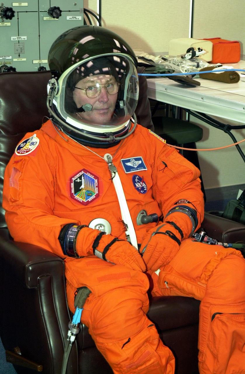 KENNEDY SPACE CENTER, FLA. -- STS-110 Mission Specialist Jerry Ross relaxes during suit fit, which is part of Terminal Countdown Demonstration Test activities. The TCDT is held at KSC prior to each Space Shuttle flight to provide flight crews an opportunity to participate in simulated launch countdown activities. Scheduled for launch April 4, the 11-day mission will feature Shuttle Atlantis docking with the International Space Station (ISS) and delivering the S0 truss, the centerpiece-segment of the primary truss structure that will eventually extend over 300 feet