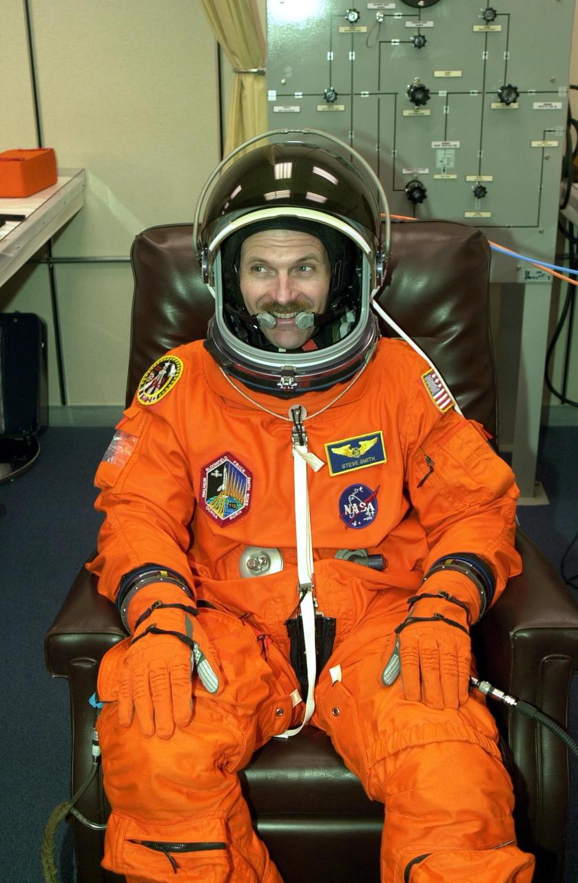 KENNEDY SPACE CENTER, FLA. -- STS-110 Mission Specialist Steven Smith relaxes during suit fit, which is part of Terminal Countdown Demonstration Test activities. The TCDT is held at KSC prior to each Space Shuttle flight to provide flight crews an opportunity to participate in simulated launch countdown activities. Scheduled for launch April 4, the 11-day mission will feature Shuttle Atlantis docking with the International Space Station (ISS) and delivering the S0 truss, the centerpiece-segment of the primary truss structure that will eventually extend over 300 feet