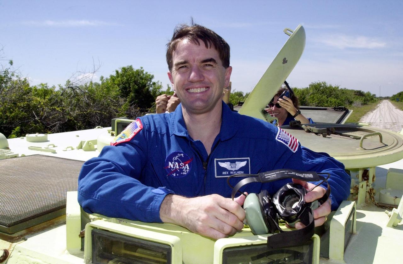 KENNEDY SPACE CENTER, FLA. --  Waiting his turn at driving the M-113 armored personnel carrier is STS-110 Mission Specialist Rex Walheim.   In the background, right, is Mission Specialist Ellen Ochoa.  The driving is part of Terminal Countdown Demonstration Test activities, which include emergency egress training and a simulated launch countdown. The TCDT is held at KSC prior to each Space Shuttle flight.  Scheduled for launch April 4, the 11-day mission will feature Shuttle Atlantis docking with the International Space Station (ISS) and delivering the S0 truss, the centerpiece-segment of the primary truss structure that will eventually extend over 300 feet