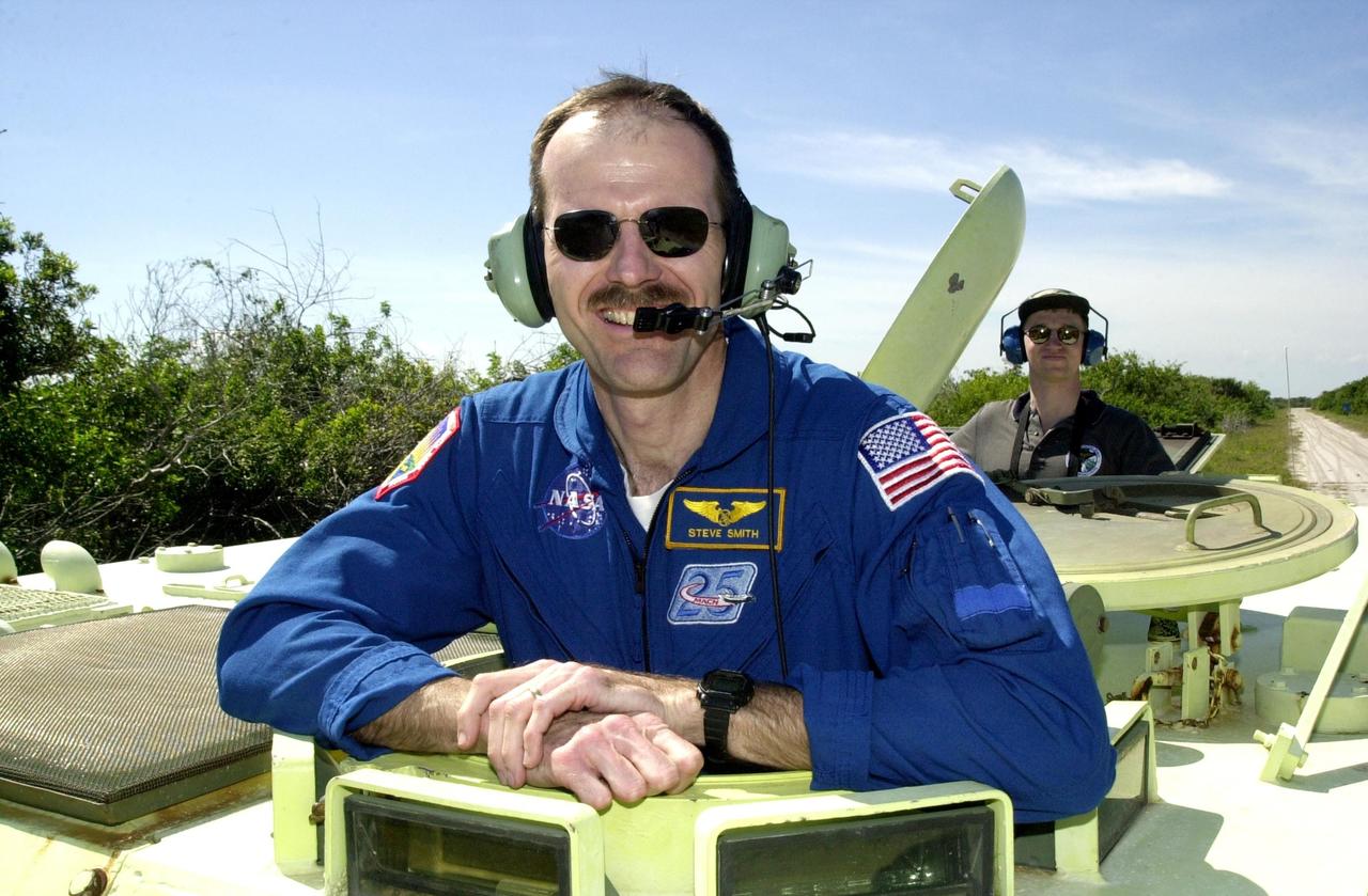 KENNEDY SPACE CENTER, FLA. --    STS-110 Mission Specialist Steven Smith waits his turn at driving the M-113 armored personnel carrier, part of Terminal Countdown Demonstration Test activities.  TCDT includes emergency egress training and a simulated launch countdown, and is held at KSC prior to each Space Shuttle flight.  Scheduled for launch April 4, the 11-day mission will feature Shuttle Atlantis docking with the International Space Station (ISS) and delivering the S0 truss, the centerpiece-segment of the primary truss structure that will eventually extend over 300 feet