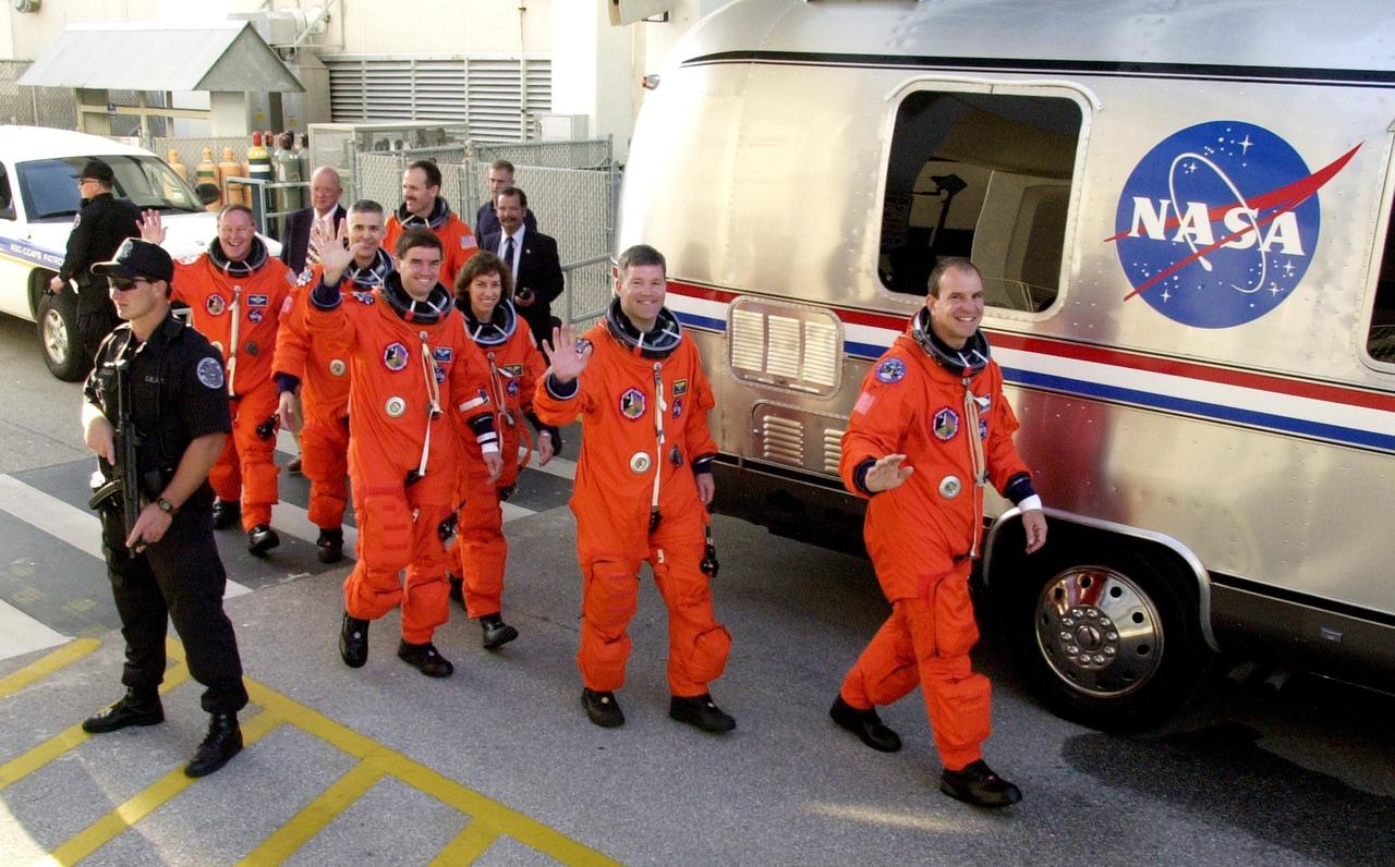 KENNEDY SPACE CENTER, FLA. --  The STS-110 crew heads for the Astrovan to take them to the launch pad and a simulated launch countdown.  From left are Mission Specialists Jerry Ross, Lee Morin, Steven Smith (rear), Rex Walheim and Ellen Ochoa; Pilot Stephen Frick and Commander Michael Bloomfield. The simulation is part of Terminal Countdown Demonstration Test activities.  TCDT also includes emergency egress training and is held at KSC prior to each Space Shuttle flight.  Scheduled for launch April 4, the 11-day mission will feature Shuttle Atlantis docking with the International Space Station (ISS) and delivering the S0 truss, the centerpiece-segment of the primary truss structure that will eventually extend over 300 feet