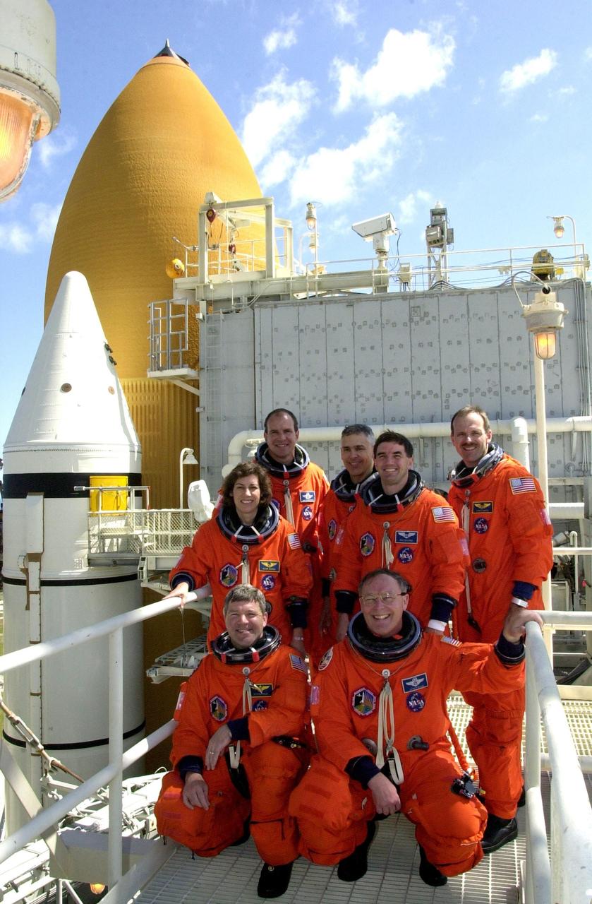 KENNEDY SPACE CENTER, FLA. --  The STS-110 crew poses on the 225-foot level of the Fixed Service Structure on the launch pad during Terminal Countdown Demonstration Test activities.  Kneeling in front are Pilot Stephen Frick and Mission Specialist Jerry Ross.  Behind them are Mission Specialists Ellen Ochoa and Rex Walheim.  In the rear are Commander Michael Bloomfield and Mission Specialists Lee Morin and Steven Smith. The TCDT, which includes emergency egress training and a simulated launch countdown, is held at KSC prior to each Space Shuttle flight.  Scheduled for launch April 4, the 11-day mission will feature Shuttle Atlantis docking with the International Space Station (ISS) and delivering the S0 truss, the centerpiece-segment of the primary truss structure that will eventually extend over 300 feet