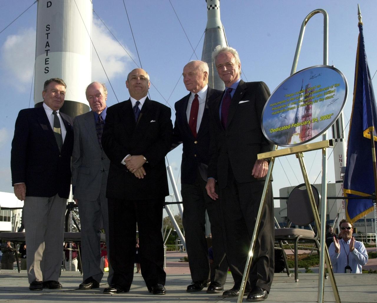 KENNEDY SPACE CENTER, FLA. --   Four space pioneers gather on stage with Rick Abramson, president of Delaware North Parks Services of Spaceport, Inc., during opening ceremonies for the 40th anniversary celebration of American spaceflight.  The former astronauts had just signed a commemorative painting of the first Mercury rocket launch to send John Glenn Jr. orbiting the Earth.  From left are Wally Schirra, Gordon Cooper, Abramson, Glenn and Scott Carpenter. The site is the Rocket Garden in the KSC Visitor Complex. The event was capped with a dinner held at the KSC Apollo/Saturn V Center