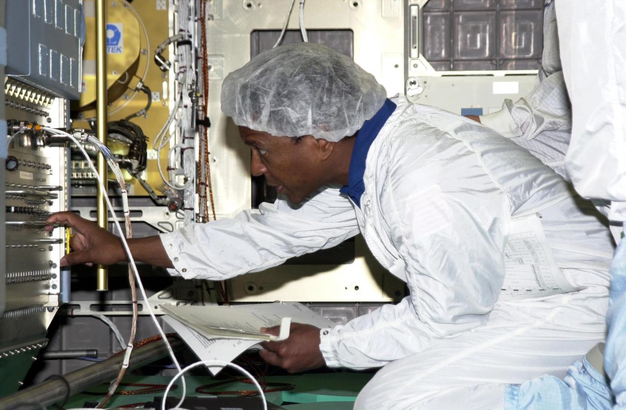 KENNEDY SPACE CENTER, FLA. -- STS-107 Payload Commander Michael Anderson checks equipment during training at SPACEHAB. STS-107 is a research mission. The primary payload is the first flight of the SHI Research Double Module (SHI/RDM). The experiments range from material sciences to life sciences (many rats). Also part of the payload is the Fast Reaction Experiments Enabling Science, Technology, Applications and Research (FREESTAR) that incorporates eight high priority secondary attached shuttle experiments. STS-107 is scheduled to launch July 11, 2002