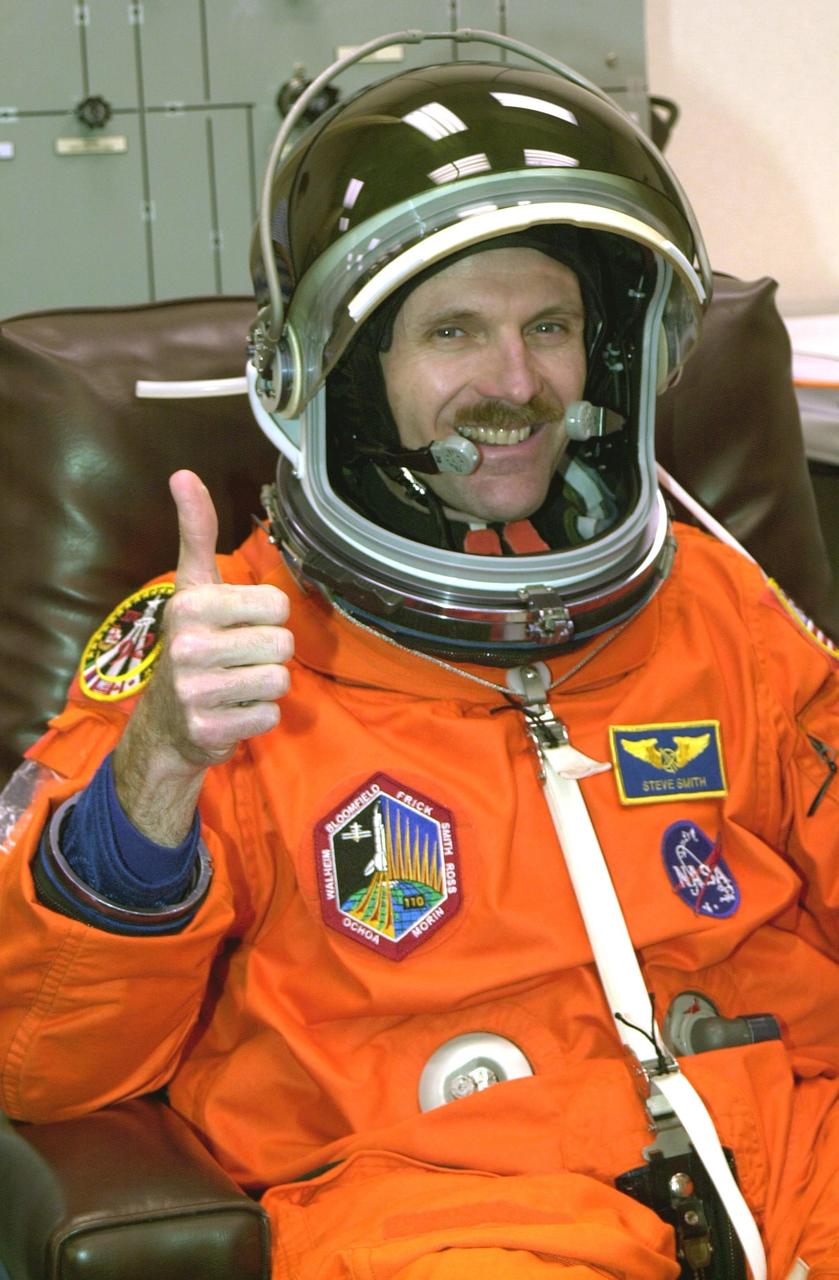 KENNEDY SPACE CENTER, FLA. -- STS-110 Mission Specialist Steven Smith gives a thumbs up for launch as he has a final check of his launch and entry suit.  This flight will be his fourth. The STS-110 payload includes the S0 Integrated Truss Structure (ITS), the Canadian Mobile Transporter, power distribution system modules, a heat pipe radiator for cooling, computers and a pair of rate gyroscopes.  The 11-day mission is the 13th assembly flight to the ISS and includes four spacewalks to attach the S0 truss to the U.S. Lab Destiny.  Launch is scheduled for April 4