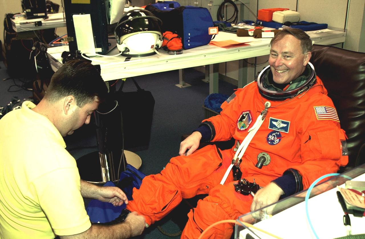 KENNEDY SPACE CENTER, FLA. --  As he undergoes a final check on his launch and entry suit, STS-110 Mission Specialist Jerry Ross shows his delight in the upcoming launch.  Ross will be making a record-breaking seventh Shuttle flight. The STS-110 payload includes the S0 Integrated Truss Structure (ITS), the Canadian Mobile Transporter, power distribution system modules, a heat pipe radiator for cooling, computers and a pair of rate gyroscopes.  The 11-day mission is the 13th assembly flight to the ISS and includes four spacewalks to attach the S0 truss to the U.S. Lab Destiny.  Launch is scheduled for April 4