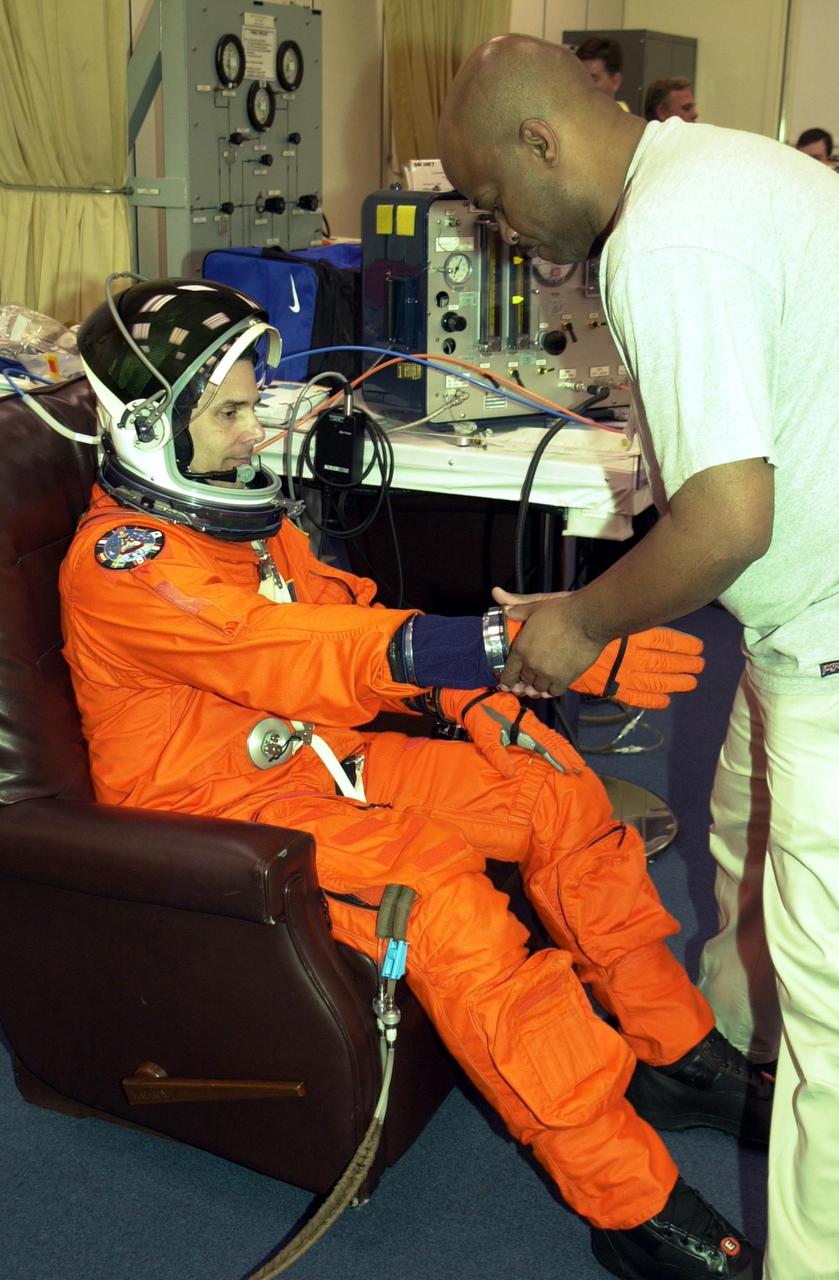 KENNEDY SPACE CENTER, FLA. --  STS-110 Mission Specialist Lee Morin undergoes final check of his launch and entry suit.  Morin will be taking his first Shuttle flight. The STS-110 payload includes the S0 Integrated Truss Structure (ITS), the Canadian Mobile Transporter, power distribution system modules, a heat pipe radiator for cooling, computers and a pair of rate gyroscopes.  The 11-day mission is the 13th assembly flight to the ISS and includes four spacewalks to attach the S0 truss to the U.S. Lab Destiny.  Launch is scheduled for April 4