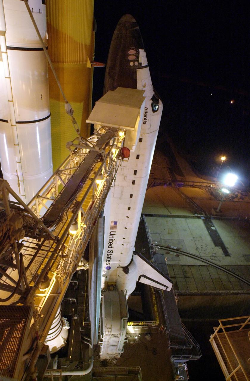 KENNEDY SPACE CENTER, FLA. --  With the Rotating Service Structure rolled back, Space Shuttle Atlantis stands ready for launch on mission STS-110.  The Orbiter Access Arm extends from the Fixed Service Structure (FSS) to the crew compartment hatch, through which the STS-110 crew will enter Atlantis.  The RSS provides protected access to the orbiter for changeout and servicing of payloads at the pad.  The structure has access platforms at five levels to provide access to the payload bay.  The FSS provides access to the orbiter and the RSS. .  Mission STS-110 is scheduled to launch April 4 on its 11-day mission to the International Space Station