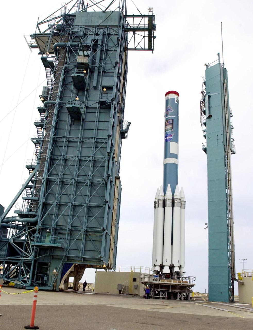 VANDENBERG AFB,CALIF. - The gantry (left) on SLC-2 moves toward the first stage of the Delta II rocket, for mating with the second stage.   The Delta II will launch the Aqua-EOS satellite. Aqua is one of a series of spacebased platforms that are central to NASA's Earth Science Enterprise (ESE), a long-term study of the scope, dynamics and implications of global change. The Aqua program is composed of Aqua and other spacecraft (including Terra and Aura) and a data distribution system (ESDIS, and Mission Operations Center Implementation Team).  Flying  in an orbit that covers the globe every 16 days, Aqua will provide a six-year chronology of the planet and its processes. Comprehensive measurements  taken by its onboard instruments will allow multidisciplinary teams of scientists and researchers from North and South  America, Asia, Australia and Europe to assess long-term  change, identify its human and natural causes and advance the development of models for long-term forecasting.  Launch is scheduled for April 26 from Vandenberg