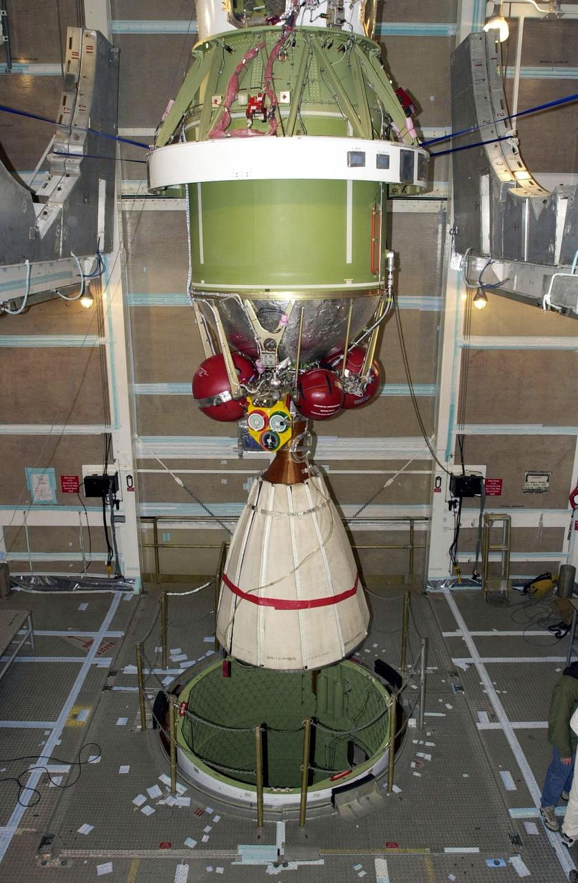 VANDENBERG AFB, CALIF. - Inside the gantry on the SLC-2 launch pad, the second stage of a Delta II rocket is lowered for mating with the first stage, below. The Delta II will launch the Aqua-EOS satellite. Aqua is one of a series of spacebased platforms that are central to NASA's Earth Science Enterprise (ESE), a long-term study of the scope, dynamics and implications of global change. The Aqua program is composed of Aqua and other spacecraft (including Terra and Aura) and a data distribution system (ESDIS, and Mission Operations Center Implementation Team).  Flying  in an orbit that covers the globe every 16 days, Aqua will provide a six-year chronology of the planet and its processes. Comprehensive measurements  taken by its onboard instruments will allow multidisciplinary teams of scientists and researchers from North and South  America, Asia, Australia and Europe to assess long-term  change, identify its human and natural causes and advance the development of models for long-term forecasting.  Launch is scheduled for April 26 from Vandenberg
