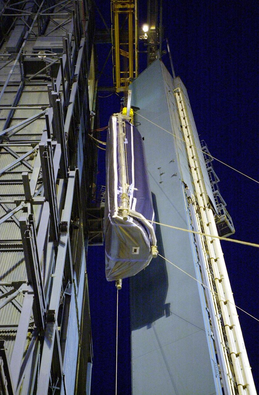 VANDENBERG AFB, CALIF. - On the SLC-2 launch pad, the first half of the Delta II fairing for the Aqua-EOS satellite is lifted up the gantry. The Delta II will launch the Aqua-EOS satellite, one of a series of spacebased platforms that are central to NASA's Earth Science Enterprise (ESE), a long-term study of the scope, dynamics and implications of global change. The Aqua program is composed of Aqua and other spacecraft (including Terra and Aura) and a data distribution system (ESDIS, and Mission Operations Center Implementation Team).  Flying  in an orbit that covers the globe every 16 days, Aqua will provide a six-year chronology of the planet and its processes. Comprehensive measurements  taken by its onboard instruments will allow multidisciplinary teams of scientists and researchers from North and South  America, Asia, Australia and Europe to assess long-term  change, identify its human and natural causes and advance the development of models for long-term forecasting.  Launch is scheduled for April 26 from Vandenberg
