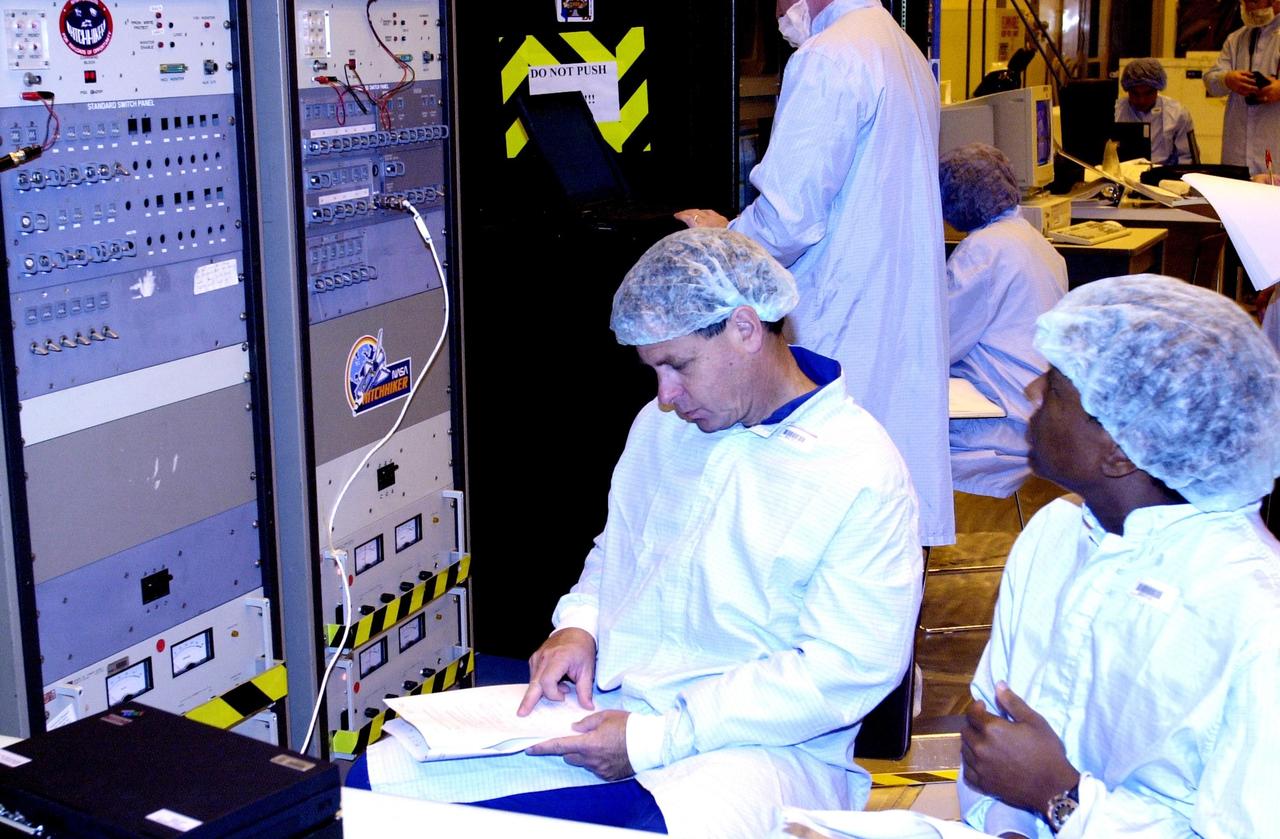 KENNEDY SPACE CENTER, FLA. -- In the Multi-Payload Processing Facility, members of the STS-107 crew look at test results on the Fast Reaction Experiments Enabling Science, Technology, Applications and Research (FREESTAR) experiments, part of the payload on their mission. A research mission, the primary payload is the first flight of the SHI Research Double Module (SHI/RDM), also known as SPACEHAB. The experiments range from material sciences to life sciences (many rats).  STS-107 is scheduled to launch July 11, 2002