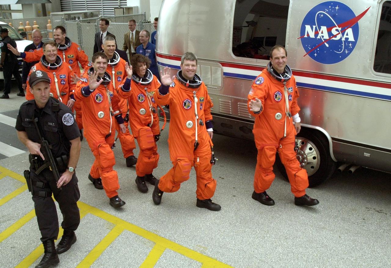 KENNEDY SPACE CENTER, FLA. --  The STS-110 crew heads for the Astrovan and a ride to Launch Pad 39B for the launch scheduled at 4:40 p.m. EDT (20:40 GMT).  From left-foreground are Mission Specialists Jerry L. Ross and Rex J. Walheim; left, second row, are Mission Specialists Steven L. Smith, Lee M.E. Morin, Ellen Ochoa; Pilot Stephen N. Frick; and Commander Michael J. Bloomfield.  STS-110 is the 13th assembly flight to the International Space Station, carrying the S0 Integrated Truss Structure and Mobile Transporter (MT).  On the 11-day mission, the mission features four spacewalks to attach the S0 truss, which will become the backbone of the Space Station, to the U.S. Lab, "Destiny."   The  MT, a space "railcar," is attached to the truss segment and will make its debut run during the flight