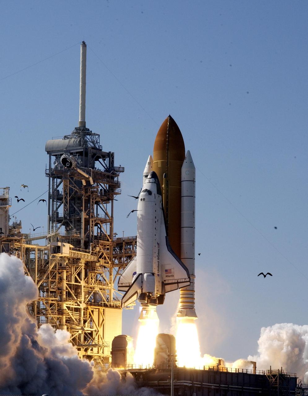 KENNEDY SPACE CENTER, FLA. - Birds scatter around Launch Pad 39B as Space Shuttle Atlantis lifts off on mission STS-110. Liftoff occurred at 4:44:19 p.m. EDT (20:41:19 GMT).  Carrying the S0 Integrated Truss Structure and Mobile Transporter, STS-110 is the 13th assembly flight to the International Space Station