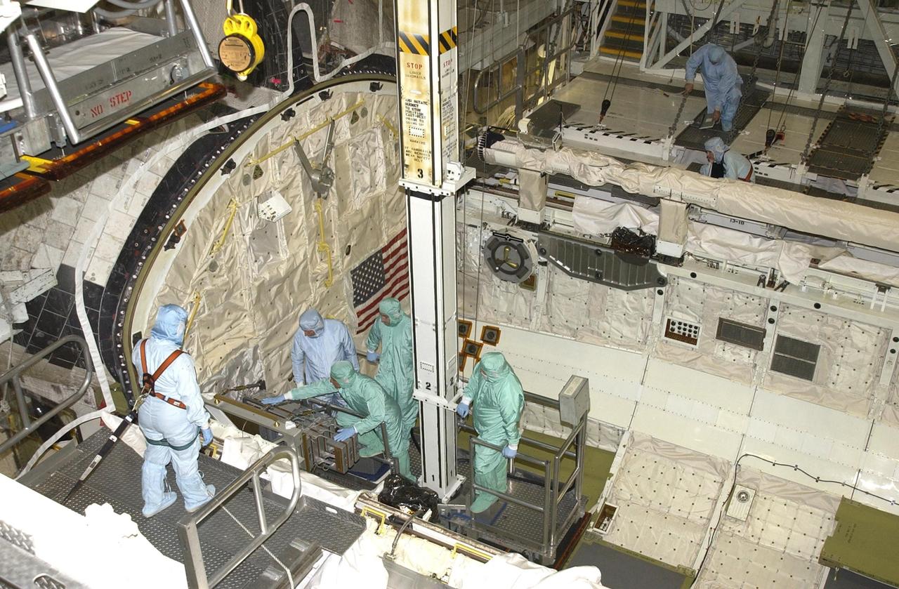 KENNEDY SPACE CENTER, FLA. --   Members of the STS-111 crew (dressed in green) look over equipment in the payload bay of Endeavour.  The crew comprises Commander Kenneth Cockrell, Pilot Paul Lockhart and Mission Specialists Franklin Chang-Diaz and Phillipe Perrin, who is with the French Space Agency (CNES).  The crew is taking part in a Crew Equipment Interface Test in preparation for launch.  Mission STS-111 will carry to the International Space Station the Multipurpose Logistics Module (MPLM), filled with experiment racks and three stowage and resupply racks, and the Mobile Base System (MBS), which will attach to the Mobile Transporter and complete the Canadian Mobile Servicing System, or MSS. The Station's mechanical arm will then have the capability to "inchworm" from the U.S. Lab to the MSS and travel along the truss to work sites on the Station.  Launch of Endeavour on mission STS-111 is scheduled for May 30, 2002