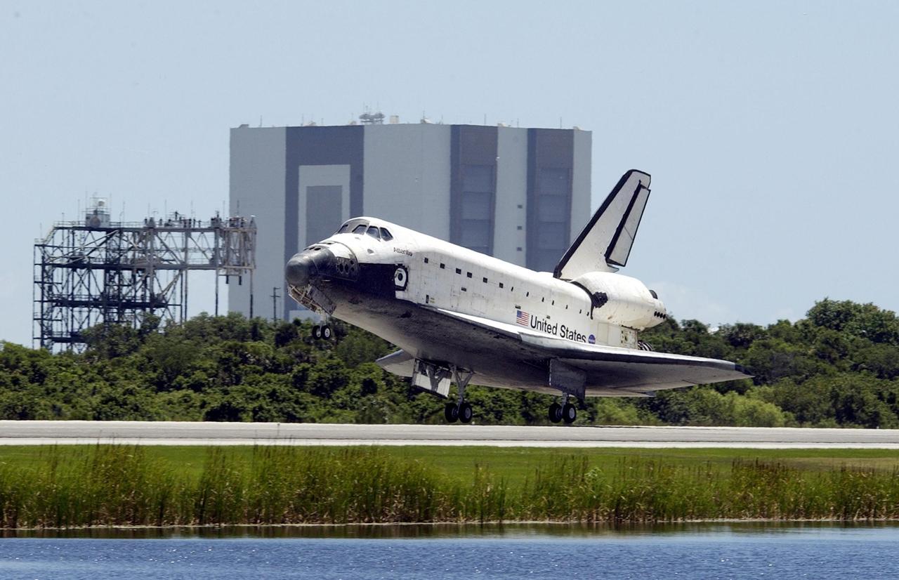 KENNEDY SPACE CENTER, FLA. -- Atlantis approaches touchdown on runway 33 at KSC's Shuttle Landing Facility. The landing completes the 10-day, 19-hour, 4.5-million mile mission STS-110 to the International Space Station. In the upper right corner is the chase plane following Atlantis' path. The orbiter carries the returning crew Commander Michael Bloomfield, Pilot Stephen Frick and Mission Specialists Jerry Ross, Steven Smith, Ellen Ochoa, Lee Morin and Rex Walheim. Main gear touchdown was 12:26:57 p.m. EDT, nose gear touchdown was 12:27:09 p.m. and wheel stop was 12:28:07 p.m. The crew delivered and installed the S0 truss, which will support cooling and power systems essential for the addition of future international laboratories, on the Station
