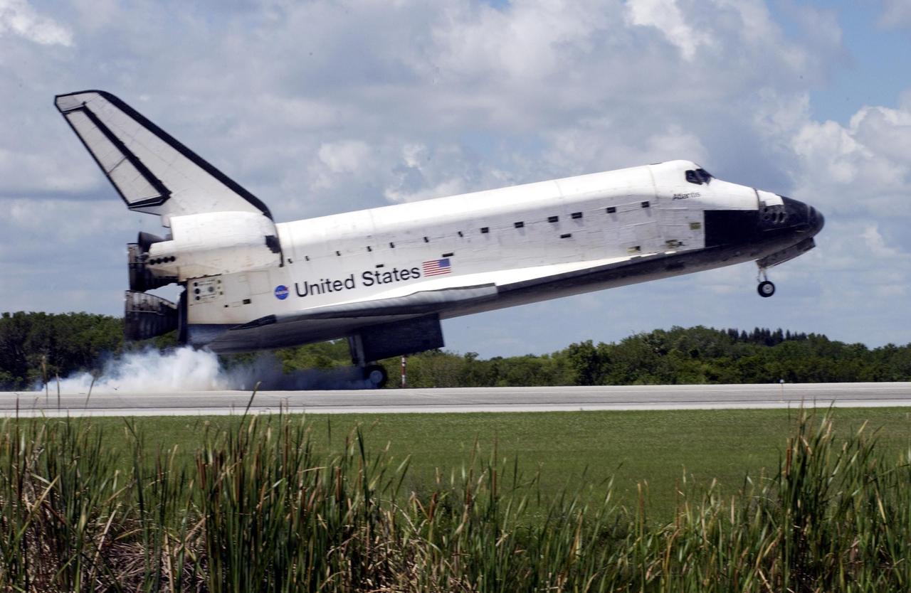 KENNEDY SPACE CENTER, FLA. -- Atlantis kicks up dust as its main gear touches down on runway 33 at KSC's Shuttle Landing Facility.  The landing completes the 10-day, 19-hour, 4.5-million mile mission STS-110 to the International Space Station. The orbiter carries the returning crew Commander Michael Bloomfield, Pilot Stephen Frick and Mission Specialists Jerry Ross, Steven Smith, Ellen Ochoa, Lee Morin and Rex Walheim.  Main gear touchdown was 12:26:57 p.m. EDT, nose gear touchdown was 12:27:09 p.m. and wheel stop was 12:28:07 p.m.  The crew delivered and installed the S0 truss, which will support cooling and power systems essential for the addition of future international laboratories, on the Station