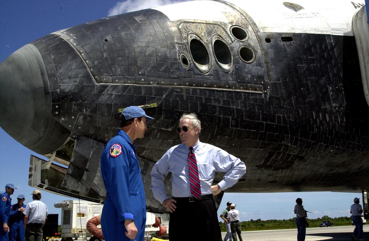 KENNEDY SPACE CENTER, FLA. -- Standing next to the nose of Atlantis, returned from its successful mission STS-110 to the International Space Station, Commander Michael Bloomfield talks with NASA Administrator Sean O'Keefe. Atlantis landed on KSC's Shuttle Landing Facility after 171 orbits, completing a 10-day, 19-hour, 4.5-million mile journey. Main gear touchdown was 12:26:57 p.m. EDT, nose gear touchdown was 12:27:09 p.m. and wheel stop was 12:28:07 p.m. The crew delivered and installed the S0 truss, which will support cooling and power systems essential for the addition of future international laboratories, on the Station