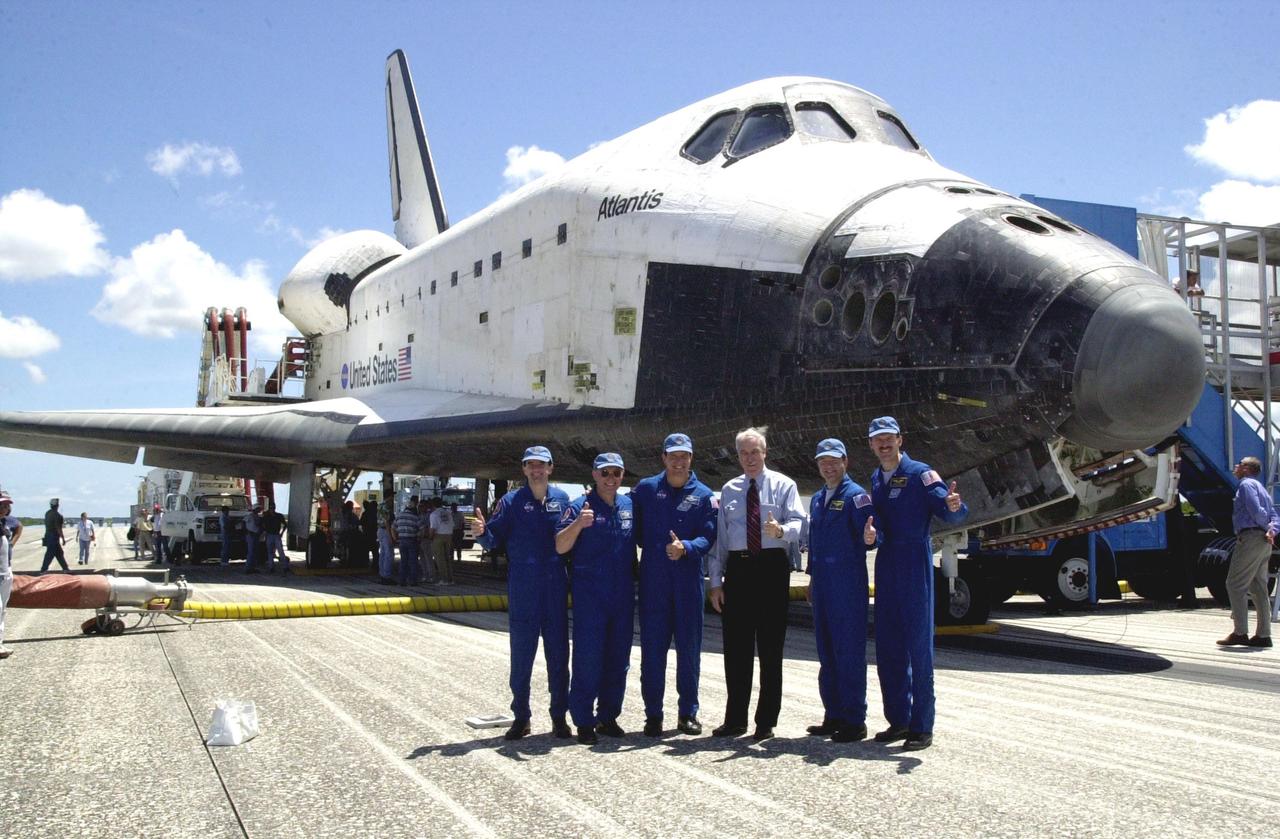 KENNEDY SPACE CENTER, FLA. --  Members of the STS-110 crew pose with NASA Administrator Sean O'Keefe in front of orbiter Atlantis after their return from the International Space Station.  Standing left to right are Mission Specialists Rex Walheim and Jerry Ross, Commander Michael Bloomfield, O'Keefe, Pilot Stephen Frick and Mission Specialist Steven Smith.  Missing crew members are Mission Specialists Ellen Ochoa and Lee Morin. Atlantis landed on KSC's Shuttle Landing Facility after 171 orbits, completing a 10-day, 19-hour, 4.5-million mile mission.  Main gear touchdown was 12:26:57 p.m. EDT, nose gear touchdown was 12:27:09 p.m. and wheel stop was 12:28:07 p.m.  The crew delivered and installed the S0 truss, which will support cooling and power systems essential for the addition of future international laboratories, on the Station