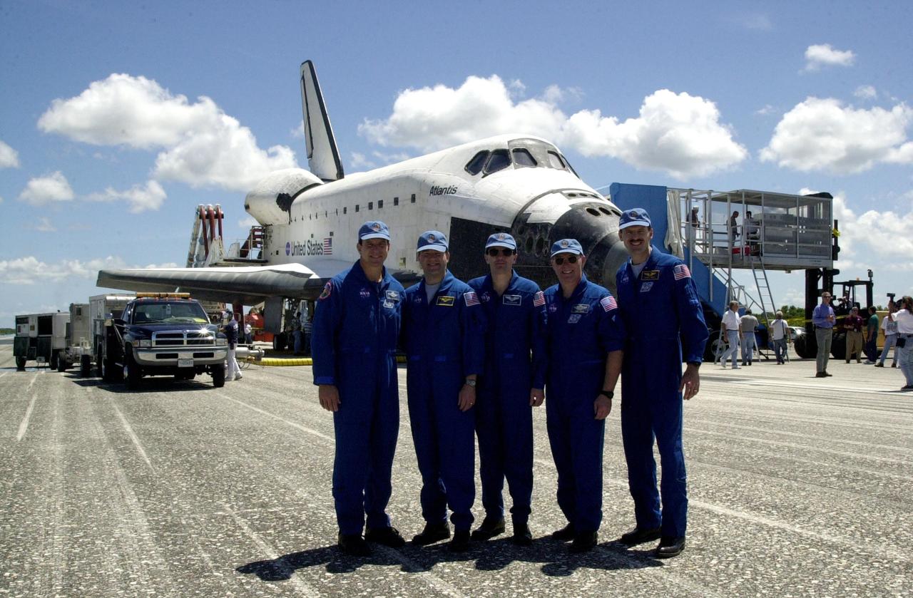 KENNEDY SPACE CENTER, FLA. -- Standing in front of Atlantis, the STS-110 crew poses for a photo.  From left are Commander Michael Bloomfield, Pilot Stephen Frick, and Mission Specialists Rex Walheim, Jerry Ross and Steven Smith.  Missing crew members are Mission Specialists Ellen Ochoa and Lee Morin.  Atlantis landed on KSC's Shuttle Landing Facility after 171 orbits, completing a 10-day, 19-hour, 4.5-million mile mission to the International Space Station. Main gear touchdown was 12:26:57 p.m. EDT, nose gear touchdown was 12:27:09 p.m. and wheel stop was 12:28:07 p.m.  The crew delivered and installed the S0 truss, which will support cooling and power systems essential for the addition of future international laboratories, on the Station