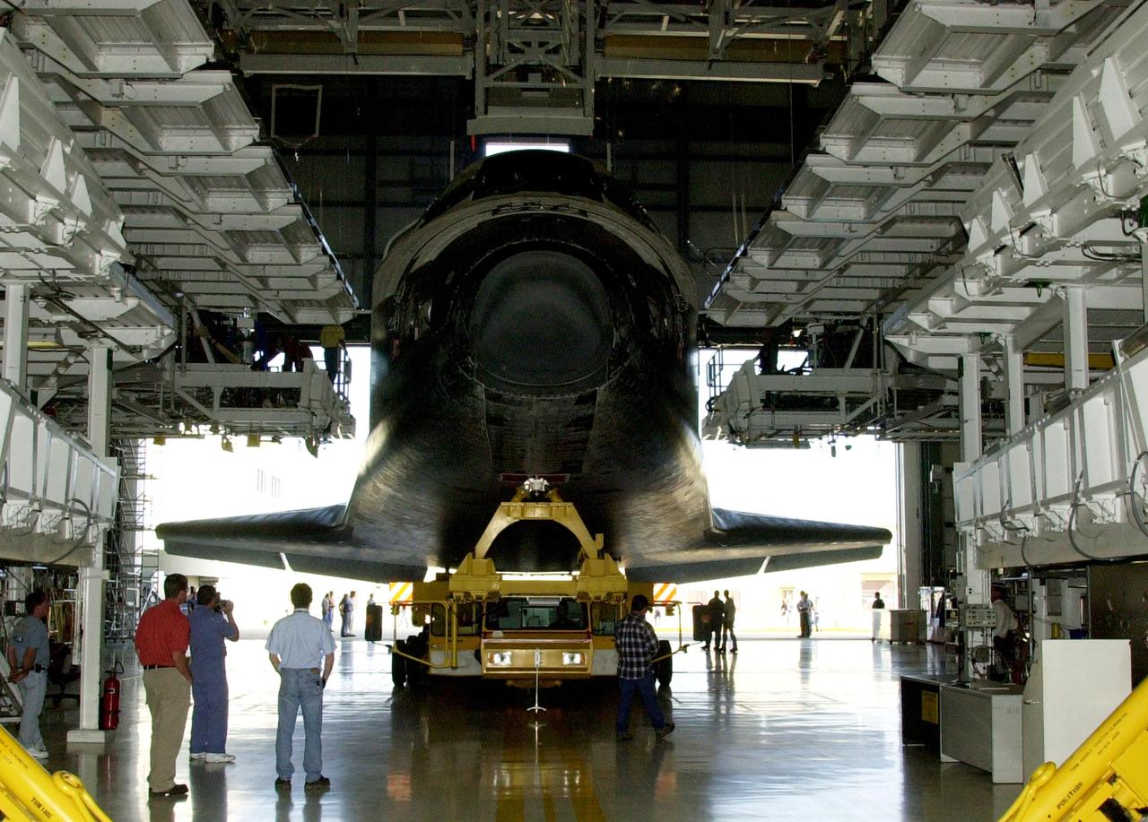 KENNEDY SPACE CENTER, FLA. -- Inside the Orbiter Processing Facility, spectators watch as Endeavour is rolled out of the bay on top of a transporter. The orbiter is being moved to the Vehicle Assembly Building for mating to the External Tank/Solid Rocket Boosters atop the Mobile Launcher Platform. Endeavour is targeted to launch May 30, 2002, on mission STS-111 to the International Space Station. Mission goals include delivering and installing the Mobile Base System to complete the Canadian Mobile Service System and carrying the Expedition 5 crew to the Station for rotation with Expedition 4.