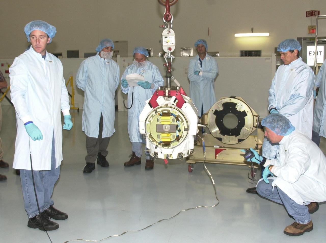 KENNEDY SPACE CENTER, FLA. --  The STS-111 crew looks at the replacement pitch roll joint for the SSRMS (Canadarm 2) they will be installing on the mission to the International Space Station.  The crew comprises Commander Kenneth Cockrell, Pilot Paul Lockhart, and Mission Specialists Franklin Chang-Diaz and Phillippe Perrin, who is with the French Space Agency.  Part of the payload on mission STS-111 is the Mobile Base System (MBS), which will be installed on the Mobile Transporter to complete the Canadian Mobile Servicing System, or MSS. The mechanical arm will then have the capability to "inchworm" from the U.S. Lab Destiny to the MSS and travel along the truss to work sites.  STS-111 is the second utilization flight (UF-2) to the Space Station and will also carry the Expedition 5 crew to replace Expedition 4.  Launch is scheduled for May 30, 2002