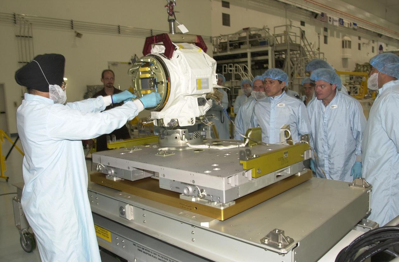 KENNEDY SPACE CENTER, FLA. -- The STS-111 crew looks at the replacement pitch roll joint for the SSRMS (Canadarm 2) they will be installing on the mission to the International Space Station.  The crew comprises Commander Kenneth Cockrell, Pilot Paul Lockhart, and Mission Specialists Franklin Chang-Diaz and Phillippe Perrin, who is with the French Space Agency.  Part of the payload on mission STS-111 is the Mobile Base System (MBS), which will be installed on the Mobile Transporter to complete the Canadian Mobile Servicing System, or MSS. The mechanical arm will then have the capability to "inchworm" from the U.S. Lab Destiny to the MSS and travel along the truss to work sites.  STS-111 is the second utilization flight (UF-2) to the Space Station and will also carry the Expedition 5 crew to replace Expedition 4.  Launch is scheduled for May 30, 2002