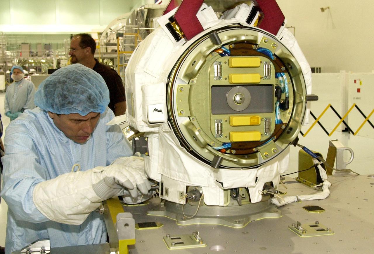 KENNEDY SPACE CENTER, FLA. -- STS-111 Mission Specialist Franklin Chang-Diaz (left) tries another maneuver on the replacement pitch roll joint for the SSRMS (Canadarm 2).  The joint will be installed during the mission to the International Space Station.  Part of the payload on mission STS-111 is the Mobile Base System (MBS), which will be installed on the Mobile Transporter to complete the Canadian Mobile Servicing System, or MSS. The mechanical arm will then have the capability to "inchworm" from the U.S. Lab Destiny to the MSS and travel along the truss to work sites.  STS-111 is the second utilization flight (UF-2) to the Space Station and will also carry the Expedition 5 crew to replace Expedition 4.  Launch is scheduled for May 30, 2002