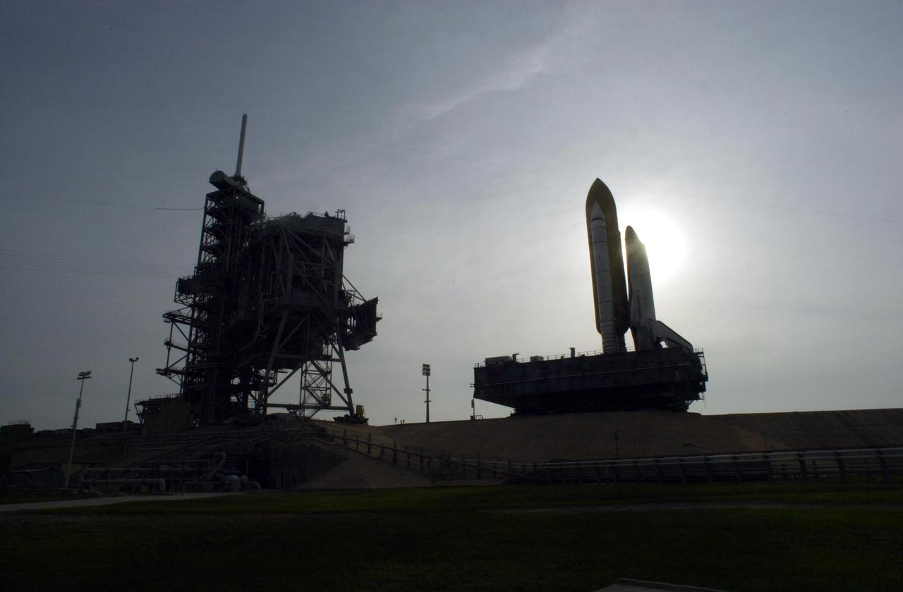 KENNEDY SPACE CENTER, FLA. - Space Shuttle Endeavour arrives at Launch Pad 39A shortly after 9 a.m. to begin processing operations for launch on mission STS-111. The slow journey along the crawlerway took 6.5 hours at a speed of 0.9 mph. The Shuttle sits atop its Mobile Launcher Platform, which travels on the crawler-transporter. At left is the open Rotating Service Structure and the Fixed Service Structure behind it, with its 80-foot lightning mast on top. Mission STS-111 is designated UF-2, the 14th assembly flight to the International Space Station. Endeavour's payload includes the Multi-Purpose Logistics Module Leonardo and Mobile Base System. The mission also will swap resident crews on the Station, carrying the Expedition 5 crew and returning to Earth Expedition 4. Liftoff of Endeavour is scheduled between 4 and 8 p.m. May 30, 2002