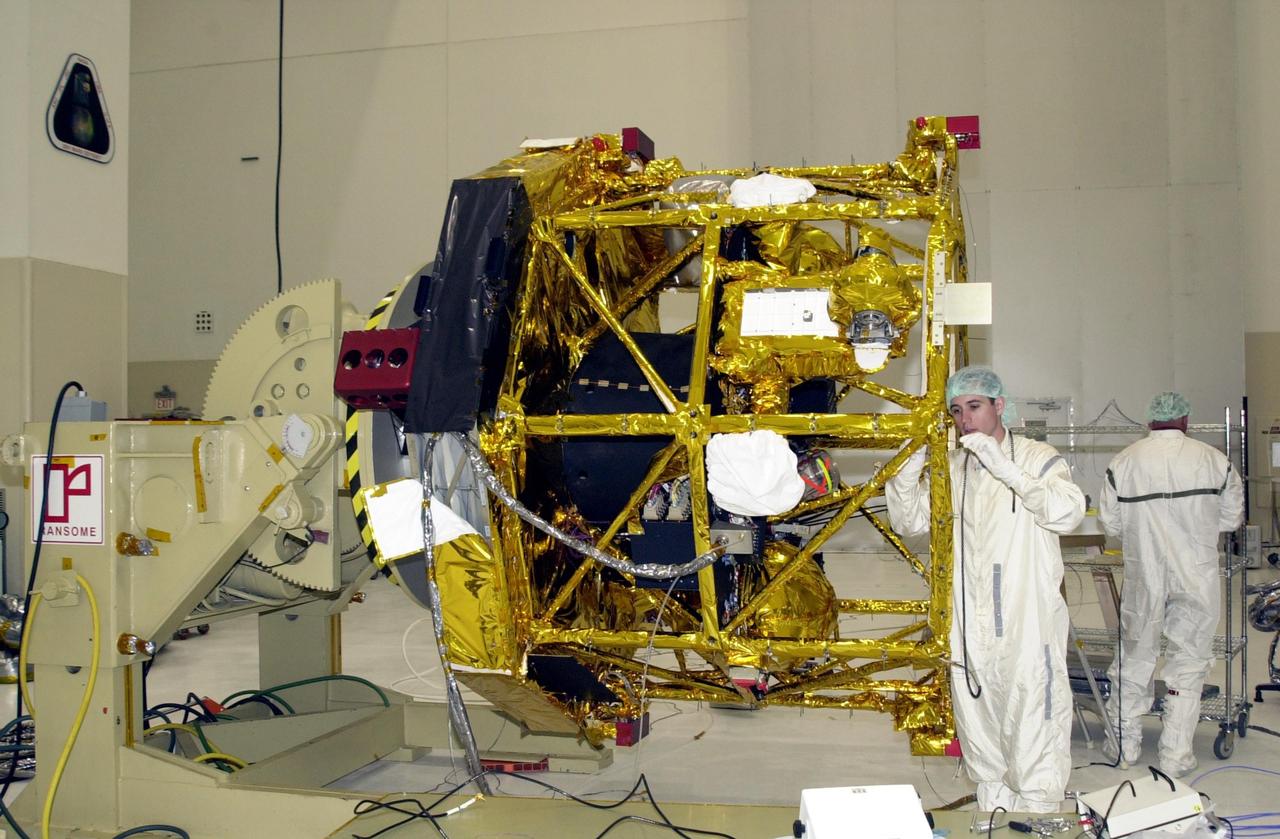 KENNEDY SPACE CENTER, FLA. - Workers in the Spacecraft Assembly and Encapsulation Facility 2 (SAEF-2) prepare the Comet Nucleus Tour (CONTOUR) spacecraft for antenna and solar panel installation. CONTOUR will provide the first detailed look into the heart of a comet -- the nucleus. The spacecraft will fly as close as 60 miles (100 kilometers) to at least two comets, Encke and Schwassmann-Wachmann 3. It will take the sharpest pictures yet of the nucleus while analyzing the gas and dust that surround these rocky, icy building blocks of the solar system. The Applied Physics Laboratory of Johns Hopkins University, Baltimore, Md., built CONTOUR and will also be in control of the spacecraft after launch, which is scheduled for July 1, 2002, from LC 17A at Cape Canaveral Air Force Station