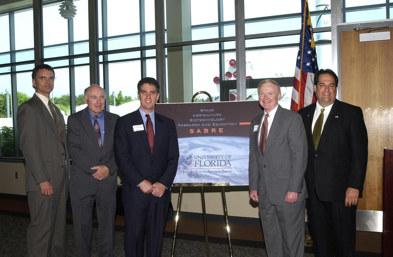 KENNEDY SPACE CENTER, FLA. -- At the opening ceremony for the new program known as SABRE, Space Agricultural Biotechnology Research and Education, key participants gather around the SABRE poster.  From left are Robert Ferl, professor in the horticultural sciences department and assistant director of the University of Florida Biotechnology Program, who will direct and be responsible for coordinating the research and education; William Knott, senior scientist in the NASA biological sciences office; U.S. Representative Dave Weldon; Center Director Roy D. Bridges Jr.; and Florida Representative Bob Allen. Involving UF and NASA,  SABRE will focus on the discovery, development and application of the biological aspects of advanced life support strategies. The program will include faculty from UF's Institute of Food and Agricultural Sciences, who will be located at both KSC - in the state-owned Space Experiment Research and Processing Laboratory (SERPL) being built there - and UF in Gainesville