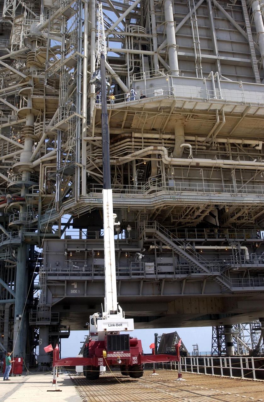 KENNEDY SPACE CENTER, FLA. -- At Launch Pad 39A, a crane lifts the replacement wrist joint for the Space Station Remote Manipulator System for installation into Space Shuttle Endeavour's payload bay. The new wrist joint, called an Orbital Replacement Unit (ORU), will be installed next to the arm's Latching End Effector during the final of three planned spacewalks. Mission STS-111 is designated UF-2, the 14th assembly flight to the International Space Station. Endeavour's payload includes the Multi-Purpose Logistics Module Leonardo and Mobile Base System. The mission also will swap resident crews on the Station, carrying the Expedition 5 crew and returning to Earth Expedition 4.  Liftoff of Endeavour is scheduled between 4 and 8 p.m. May 30, 2002