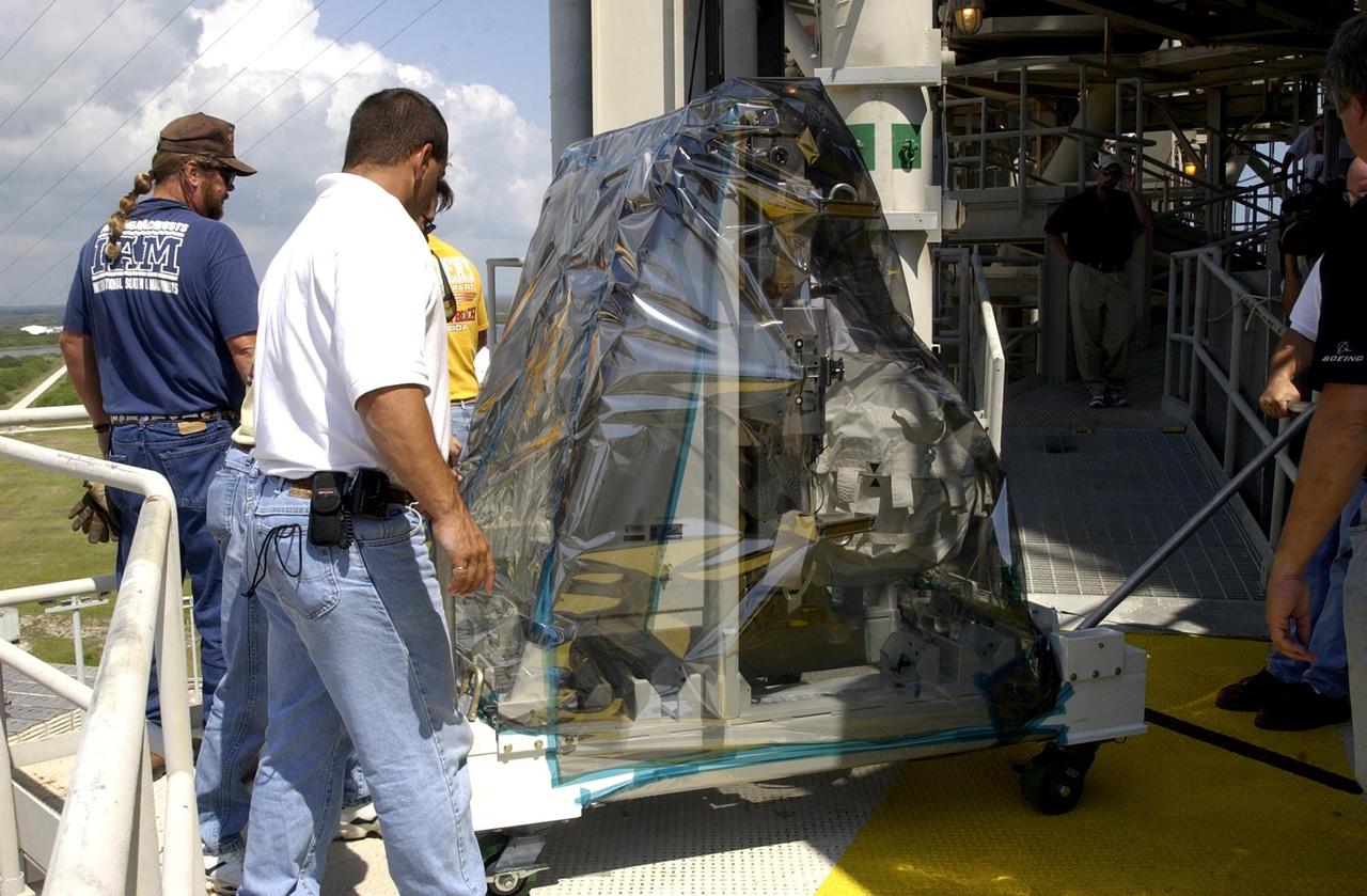 KENNEDY SPACE CENTER, FLA. -- Technicians unload the replacement wrist joint for the Space Station Remote Manipulator System before installing it in Space Shuttle Endeavour's payload bay. The new wrist joint, called an Orbital Replacement Unit (ORU), will be installed next to the arm's Latching End Effector during the final of three planned spacewalks. Mission STS-111 is designated UF-2, the 14th assembly flight to the International Space Station. Endeavour's payload includes the Multi-Purpose Logistics Module Leonardo and Mobile Base System. The mission also will swap resident crews on the Station, carrying the Expedition 5 crew and returning to Earth Expedition 4. Liftoff of Endeavour is scheduled between 4 and 8 p.m. May 30, 2002