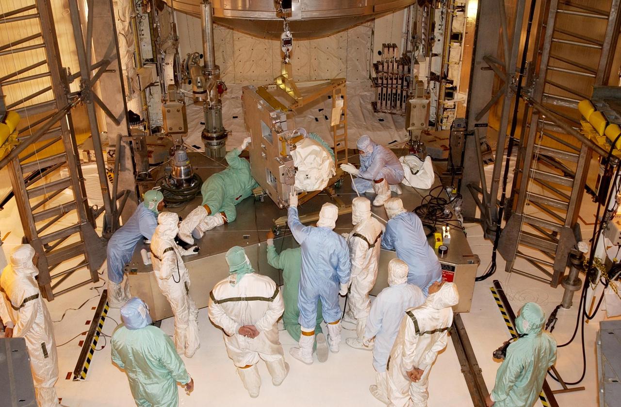 KENNEDY SPACE CENTER, FLA. -- Technicians install the replacement wrist joint for the Space Station Remote Manipulator System into Space Shuttle Endeavour's payload bay. The new wrist joint, called an Orbital Replacement Unit (ORU), will be installed next to the arm's Latching End Effector during the final of three planned spacewalks. Mission STS-111 is designated UF-2, the 14th assembly flight to the International Space Station. Endeavour's payload includes the Multi-Purpose Logistics Module Leonardo and Mobile Base System. The mission also will swap resident crews on the Station, carrying the Expedition 5 crew and returning to Earth Expedition 4. Liftoff of Endeavour is scheduled between 4 and 8 p.m. May 30, 2002