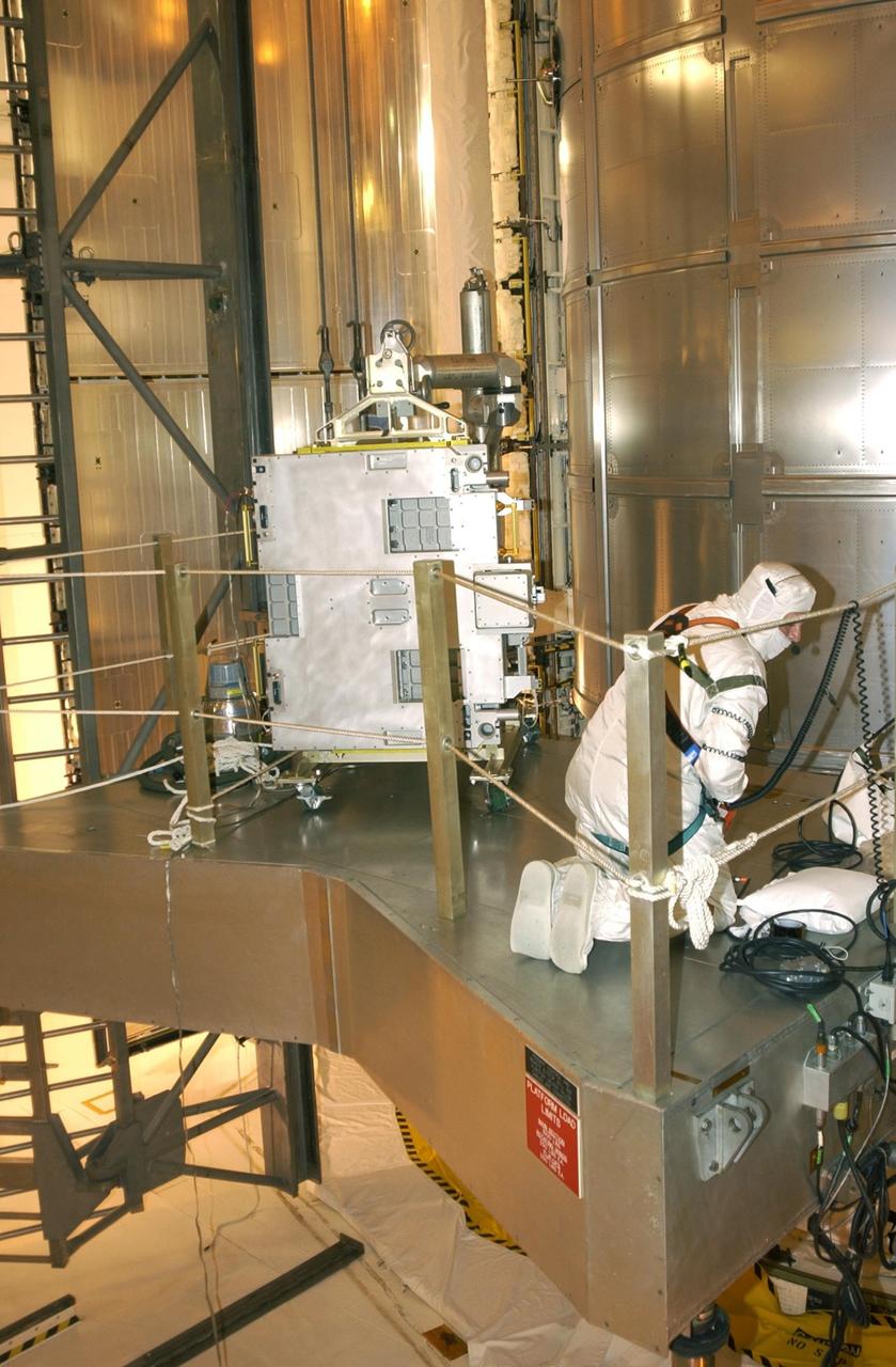 KENNEDY SPACE CENTER, FLA. -- At Pad 39A, technicians install the replacement wrist joint for the Space Station Remote Manipulator System into Space Shuttle Endeavour's payload bay. The new wrist joint, called an Orbital Replacement Unit (ORU), will be installed next to the arm's Latching End Effector during the final of three planned spacewalks. Mission STS-111 is designated UF-2, the 14th assembly flight to the International Space Station. Endeavour's payload includes the Multi-Purpose Logistics Module Leonardo and Mobile Base System. The mission also will swap resident crews on the Station, carrying the Expedition 5 crew and returning to Earth Expedition 4. Liftoff of Endeavour is scheduled between 4 and 8 p.m. May 30, 2002