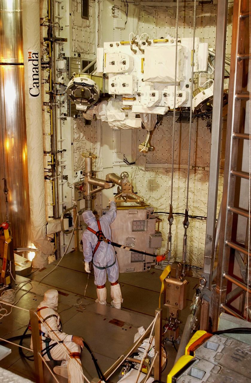 KENNEDY SPACE CENTER, FLA. -- At Pad 39A, technicians install the replacement wrist joint for the Space Station Remote Manipulator System into Space Shuttle Endeavour's payload bay. The new wrist joint, called an Orbital Replacement Unit (ORU), will be installed next to the arm's Latching End Effector during the final of three planned spacewalks. Mission STS-111 is designated UF-2, the 14th assembly flight to the International Space Station. Endeavour's payload includes the Multi-Purpose Logistics Module Leonardo and Mobile Base System. The mission also will swap resident crews on the Station, carrying the Expedition 5 crew and returning to Earth Expedition 4. Liftoff of Endeavour is scheduled between 4 and 8 p.m. May 30, 2002