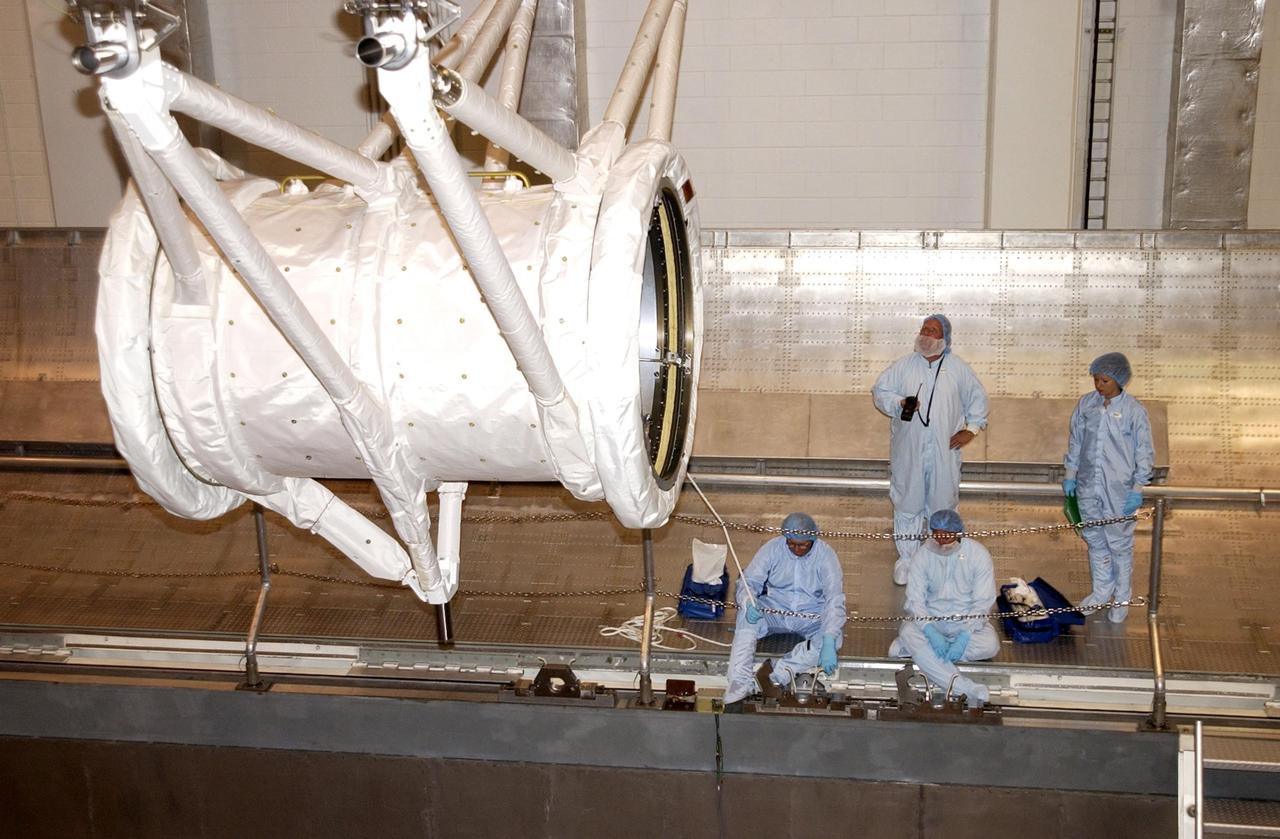 KENNEDY SPACE CENTER, FLA. -- Processing for mission STS-107 continues in the Operations and Checkout Building as the tunnel that will connect Space Shuttle Columbia's crew compartment to the SPACEHAB module is moved into a transportation canister.  A research mission, the primary payload of STS-107 is the SHI Research Double Module (SHI/RDM) or SPACEHAB, making its first flight. The experiments on board will range from material sciences to life sciences (many rats). STS-107 is scheduled to launch July 19, 2002