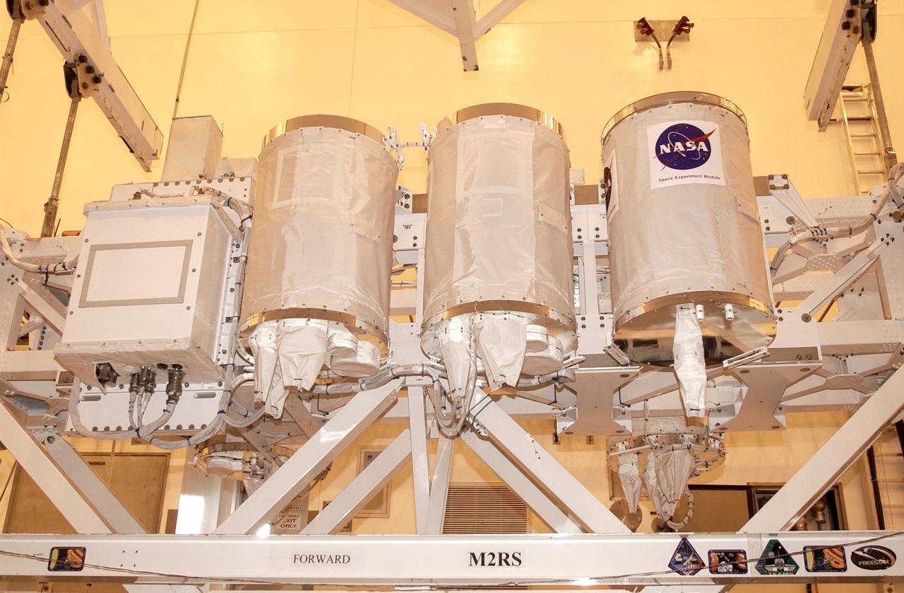 KENNEDY SPACE CENTER, FLA. - In the Multi-Payload Processing Facility, the Hitchhiker Bridge with GetAway Special canisters (GAS cans) are ready for transfer to the payload canister. The bridge is a carrier for the Fast Reaction Experiments Enabling Science, Technology, Applications and Research (FREESTAR) that incorporates eight high priority secondary attached shuttle experiments on mission STS-107. The bridge will be installed in Columbia's payload bay. A research mission, STS-107 will also carry the SHI Research Double Module (SHI/RDM), known as SPACEHAB. Experiments on the module range from material sciences to life sciences (many rats). STS-107 is scheduled to launch July 19, 2002