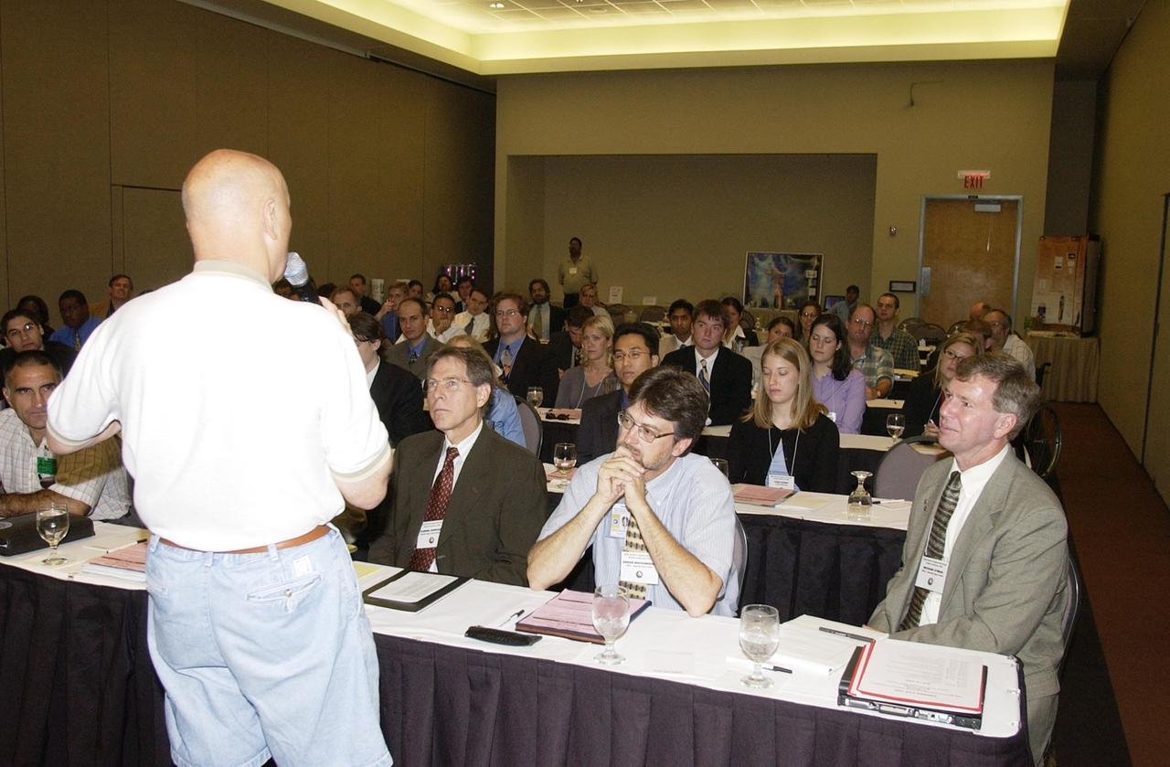 KENNEDY SPACE CENTER, FLA. -- Former astronaut Story Musgrave speaks to students and faculty from across the nation gathered at the KSC Visitor Complex for this year's NASA MarsPort Engineering Design Student Competition 2002 conference.   The participants are presenting papers on engineering trade studies to design optimal configurations for a MarsPort Deployable Greenhouse for operation on the surface of Mars.  Judges in the competition were from KSC, Dynamac Corporation and Florida Institute of Technology.   The winning team's innovative ideas will be used by NASA to evaluate and study other engineering trade concepts. Featured at the opening ceremony were Dr. Sam Durrance, FSGC director and former astronaut, and Dr. Gary Stutte, plant scientist, Dynamac Corporation. 