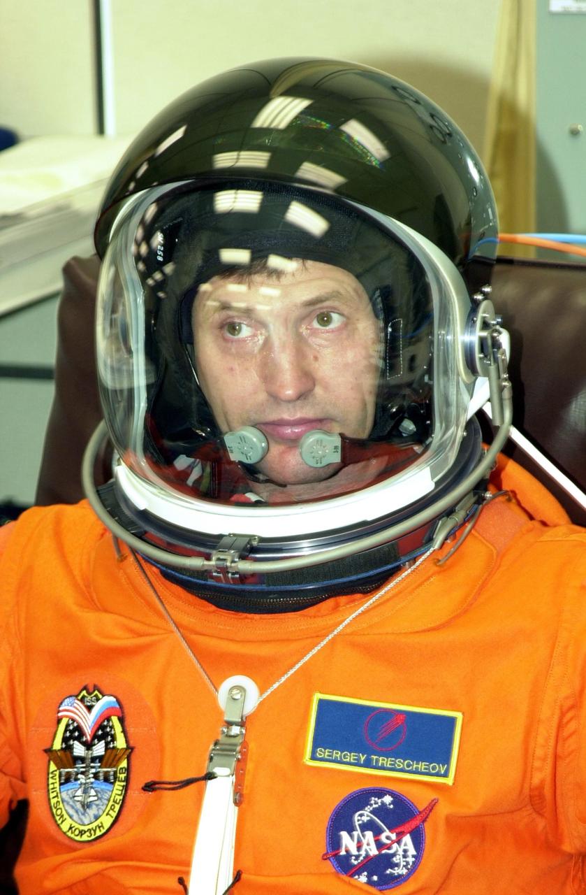 KENNEDY SPACE CENTER, FLA. -- Expedition 5 crew member Sergei Treschev, with the Russian Space Agency, wears the helmet with his launch and entry suit during suit check, part of Terminal Countdown Demonstration Test activities at KSC. The TCDT includes emergency egress training at the pad and a simulated launch countdown. Expedition 5 will travel to the International Space Station as the replacement crew for Expedition 4, who will return to Earth aboard Endeavour. Known as Utilization Flight -2, the mission includes attaching a Canadian-built mobile base system to the International Space Station that will enable the Canadarm2 robotic arm to move along a railway on the Station's truss to build and maintain the outpost. The crew will also replace a faulty wrist/roll joint on the Canadarm2 as well as unload almost three tons of experiments and supplies from the Italian-built Multi-Purpose Logistics Module Leonardo. Launch of Space Shuttle Endeavour on mission STS-111 is scheduled for May 30, 2002