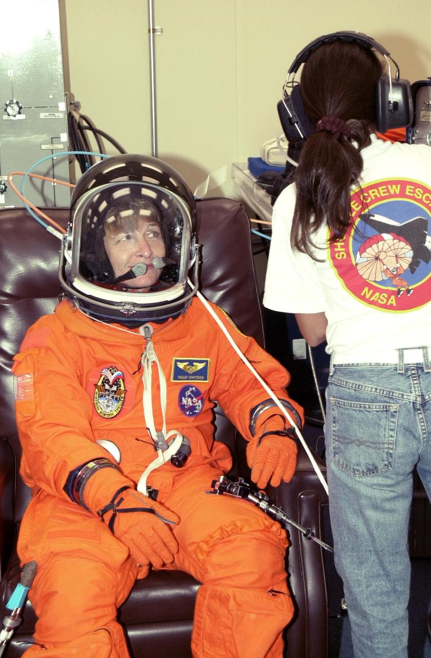 KENNEDY SPACE CENTER, FLA. -- During suit check, Expedition 5 crew member Peggy Whitson undergoes suit check as part of Terminal Countdown Demonstration Test activities at KSC. The TCDT includes emergency egress training at the pad and a simulated launch countdown. Expedition 5 will travel to the International Space Station on mission STS-111 as the replacement crew for Expedition 4, who will return to Earth aboard Endeavour. Known as Utilization Flight -2, the mission includes attaching a Canadian-built mobile base system to the International Space Station that will enable the Canadarm2 robotic arm to move along a railway on the Station's truss to build and maintain the outpost. The crew will also replace a faulty wrist/roll joint on the Canadarm2 as well as unload almost three tons of experiments and supplies from the Italian-built Multi-Purpose Logistics Module Leonardo. Launch of Space Shuttle Endeavour on mission STS-111 is scheduled for May 30, 2002