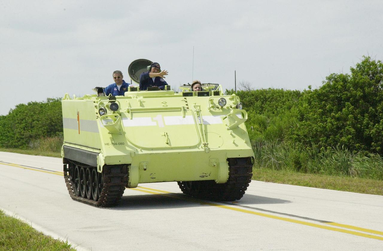 KENNEDY SPACE CENTER, FLA. -- During Terminal Countdown Demonstration Test activities at KSC, Expedition 5 member Peggy Whitson drives the M-113 armored personnel carrier, used for emergency egress training at the pad. Passengers in the vehicle are Expedition 5 Commander Valeri Korzun and George Hoggard (center), with the KSC/CCAS Fire Department, who supervises the driving. Expedition 5 will travel to the International Space Station on mission STS-111 as the replacement crew for Expedition 4, who will return to Earth aboard Endeavour. The TCDT also includes a simulated launch countdown Known as Utilization Flight -2, the mission includes attaching a Canadian-built mobile base system to the International Space Station that will enable the Canadarm2 robotic arm to move along a railway on the Station's truss to build and maintain the outpost. The crew will also replace a faulty wrist/roll joint on the Canadarm2 as well as unload almost three tons of experiments and supplies from the Italian-built Multi-Purpose Logistics Module Leonardo. Launch of Space Shuttle Endeavour on mission STS-111 is scheduled for May 30, 2002