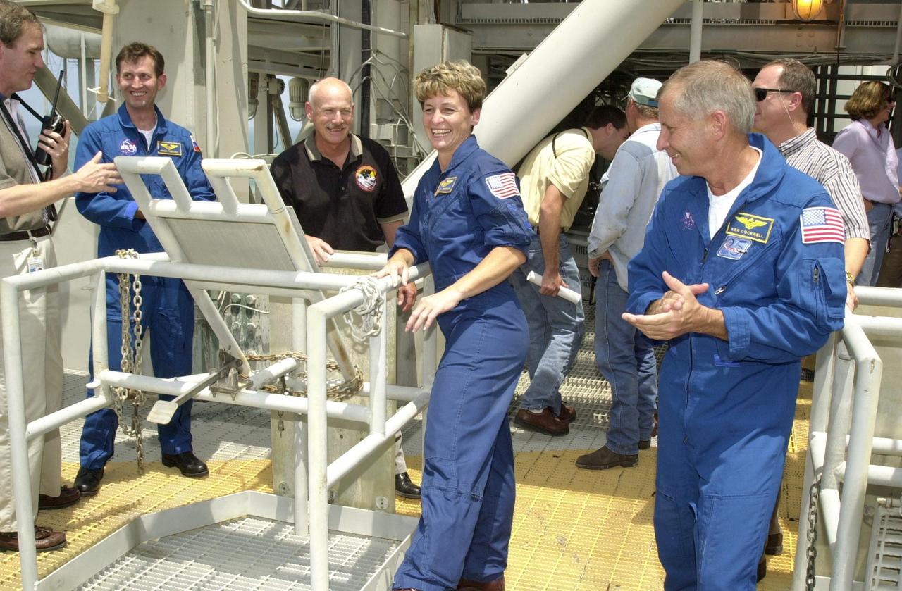 KENNEDY SPACE CENTER, FLA. - Members of the STS-111 and Expedition 5 crews take part in emergency egress training on Launch Pad 39A.  From Expedition 5 are, left, in the blue suit, Sergei Treschev and, center, Peggy Whitson.  At right is Mission Commander Kenneth Cockrell. The training is part of Terminal Countdown Demonstration Test activities for the two crews.  The TCDT also includes a simulated launch countdown.  Mission STS-111 is known as Utilization Flight 2, carrying supplies and equipment in the Multi-Purpose Logistics Module Leonardo to the International Space Station.  The payload also includes the Mobile Base System, which will be installed on the Mobile Transporter to complete the Canadian Mobile Servicing System, or MSS, and a replacement wrist/roll joint for Canadarm 2. The mechanical arm will then have the capability to "inchworm" from the U.S. Lab Destiny to the MSS and travel along the truss to work sites.   Expedition 5 will travel to the Station on Endeavour as the replacement crew for Expedition 4, who will return to Earth aboard the orbiter.  Launch is scheduled for May 30, 2002