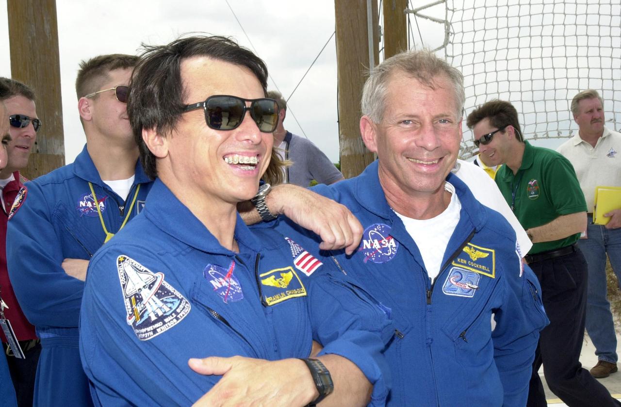 KENNEDY SPACE CENTER, FLA. - During emergency egress training at the pad, STS-111 Mission Specialist Franklin Chang-Diaz (left, foreground) and Commander Kenneth Cockrell share a lighthearted moment. Behind Chang-Diaz is Expedition 5 Commander Valeri Korzun. The training is part of Terminal Countdown Demonstration Test activities, which also include a simulated launch countdown. Mission STS-111 is known as Utilization Flight 2, carrying supplies and equipment in the Multi-Purpose Logistics Module Leonardo to the International Space Station. The payload also includes the Mobile Base System, which will be installed on the Mobile Transporter to complete the Canadian Mobile Servicing System, or MSS, and a replacement wrist/roll joint for Canadarm 2. The mechanical arm will then have the capability to "inchworm" from the U.S. Lab Destiny to the MSS and travel along the truss to work sites. Expedition 5 will travel to the Station on Endeavour as the replacement crew for Expedition 4, who will return to Earth aboard the orbiter. Launch is scheduled for May 30, 2002