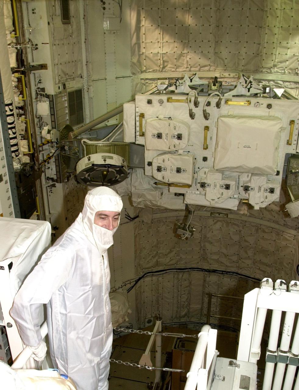 KENNEDY SPACE CENTER, FLA.  -- In the Orbiter Processing Facility, STS-111 Mission Specialist Philippe Perrin, with the French Space Agency, looks over the payload installed in Endeavour's payload bay.  The crew is at KSC for Terminal Countdown Demonstration Test activities, which include payload familiarization and a simulated launch countdown.  The crew also comprises Commander Kenneth Cockrell, Pilot Paul Lockhart and Mission Specialist Franklin Chang-Diaz.  The payload on mission STS-111 to the International Space Station includes the Mobile Base System, an Orbital Replacement Unit and Multi-Purpose Logistics Module Leonardo.   Traveling on Endeavour is also the Expedition 5 crew - Commander Valeri Korzun, Peggy Whitson and Sergei Treschev -- who will replace the Expedition 4 crew on the Station.  Korzun and Treschev are with the Russian Space Agency.  Launch of Endeavour is scheduled for May 30, 2002