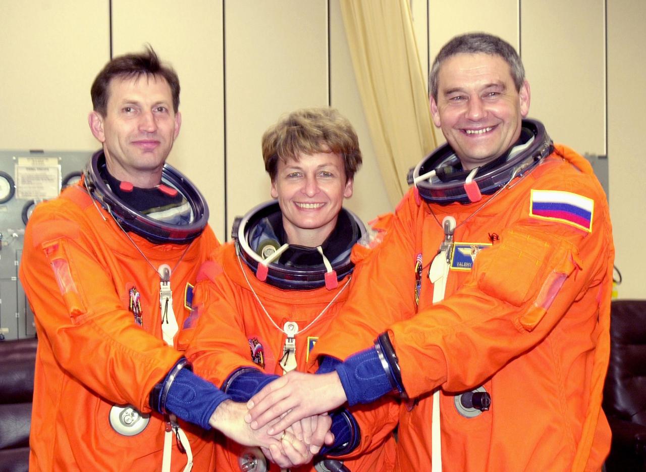 KENNEDY SPACE CENTER, FLA. --  The Expedition 5 crew poses during suitup prior to going to the launch pad for a simulated countdown.  From left are astronaut Sergei Treschev, astronaut Peggy Whitson and Commander Valeri Korzun.  Treschev and Korzun are with the Russian Space Agency.    The simulation is part of STS-111 Terminal Countdown Demonstration Test activities, which also includes the mission crew Commander Kenneth Cockrell, Pilot Paul Lockhart and Mission Specialists Franklin Chang-Diaz and Philippe Perrin, with the French Space Agency. The payload on the mission to the International Space Station includes the Mobile Base System, an Orbital Replacement Unit and Multi-Purpose Logistics Module Leonardo.  The Expedition 5 crew is traveling on Endeavour to replace the Expedition 4 crew on the Station.  Launch of Endeavour is scheduled for May 30, 2002.