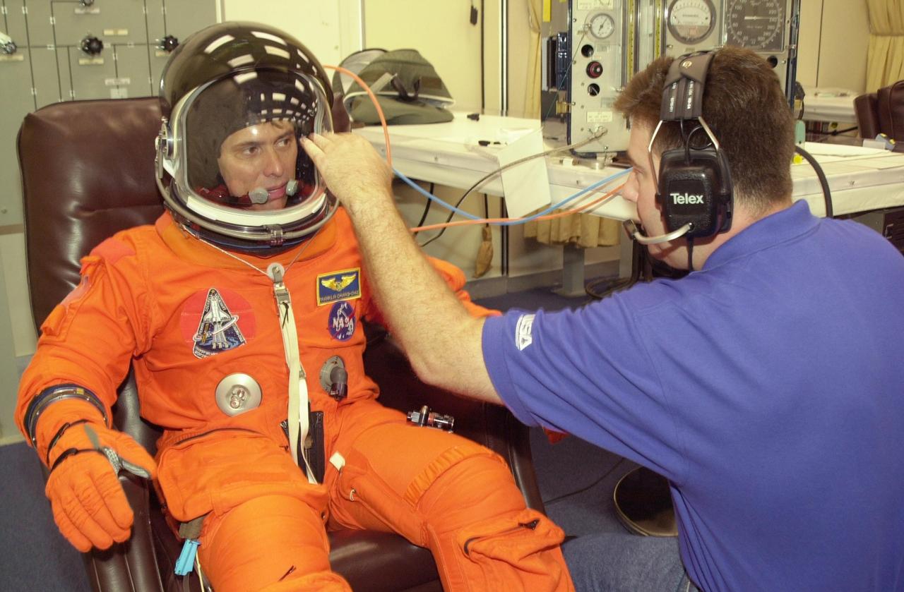 KENNEDY SPACE CENTER, FLA. --  STS-111 Mission Specialist Franklin Chang-Diaz gets ready in his launch and entry suit for a simulated launch countdown at the pad. The simulation is part of STS-111 Terminal Countdown Demonstration Test activities for the crew and Expedition 5. The payload on the mission to the International Space Station includes the Mobile Base System, an Orbital Replacement Unit and Multi-Purpose Logistics Module Leonardo.  The Expedition 5 crew is traveling on Endeavour to replace the Expedition 4 crew on the Station.  Launch of Endeavour is scheduled for May 30, 2002.