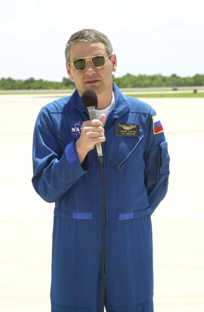 KENNEDY SPACE CENTER, FLA. -- Expedition 5 Commander Valeri Korzun (with microphone) speaks to the media before leaving KSC.  The Expedition 5 and STS-111 crews have been taking part in Terminal Countdown Demonstration Test activities that include emergency egress training and a simulated launch countdown. Expedition 5 will travel to the International Space Station on mission STS-111 as the replacement crew for Expedition 4, who will return to Earth aboard the orbiter. Mission STS-111 is known as Utilization Flight 2, carrying supplies and equipment in the Multi-Purpose Logistics Module Leonardo to the International Space Station.  The payload also includes the Mobile Base System, which will be installed on the Mobile Transporter to complete the Canadian Mobile Servicing System, or MSS, and a replacement wrist/roll joint for Canadarm 2. The mechanical arm will then have the capability to "inchworm" from the U.S. Lab Destiny to the MSS and travel along the truss to work sites. Launch is scheduled for May 30, 2002