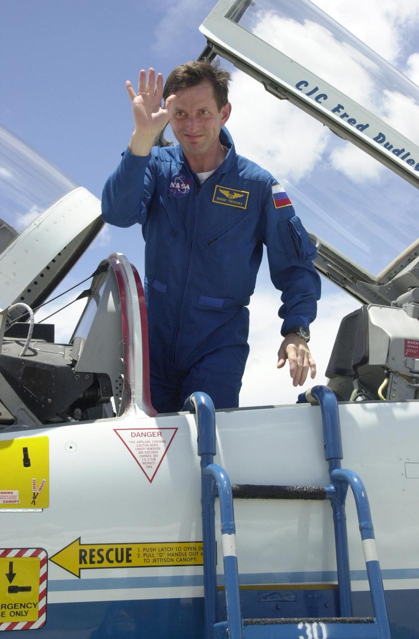 KENNEDY SPACE CENTER, FLA. -- Expedition 5 cosmonaut Sergei Treschev, who is with the Russian Space Agency,  waves from the T-38 jet aircraft before disembarking to prepare for launch on mission STS-111. Expedition 5 will travel to the Station on Space Shuttle Endeavour as the replacement crew for Expedition 4, who will return to Earth aboard the orbiter.  Mission STS-111, known as Utilization Flight 2, is carrying supplies and equipment to the International Space Station. The payload includes the Multi-Purpose Logistics Module Leonardo, the Mobile Base System, which will be installed on the Mobile Transporter to complete the Canadian Mobile Servicing System, or MSS, and a replacement wrist/roll joint for Canadarm 2. The mechanical arm will then have the capability to "inchworm" from the U.S. Lab Destiny to the MSS and travel along the truss to work sites. Launch is scheduled for May 30, 2002