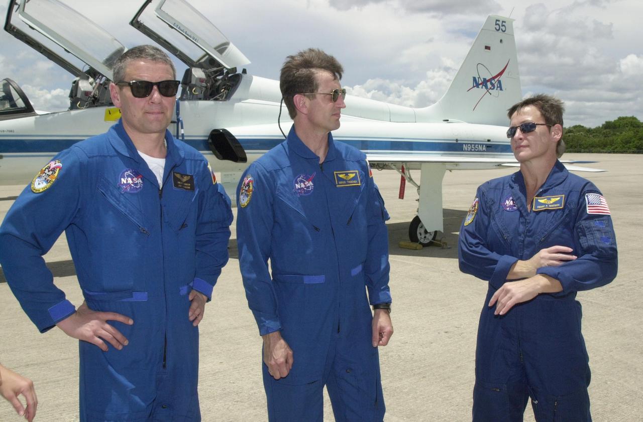 KENNEDY SPACE CENTER, FLA. --  Expedition 5 crew members Commander Valeri Korzun, cosmonaut Sergei Treschev and astronaut Peggy Whitson get together after landing at the Shuttle Landing Facility to prepare for launch on mission STS-111. Korzun and Treschev are with the Russian Space Agency.  Expedition 5 will travel to the Station on Space Shuttle Endeavour as the replacement crew for Expedition 4, who will return to Earth aboard the orbiter.  Mission STS-111, known as Utilization Flight 2, is carrying supplies and equipment to the International Space Station. The payload includes the Multi-Purpose Logistics Module Leonardo, the Mobile Base System, which will be installed on the Mobile Transporter to complete the Canadian Mobile Servicing System, or MSS, and a replacement wrist/roll joint for Canadarm 2. The mechanical arm will then have the capability to "inchworm" from the U.S. Lab Destiny to the MSS and travel along the truss to work sites. Launch is scheduled for May 30, 2002